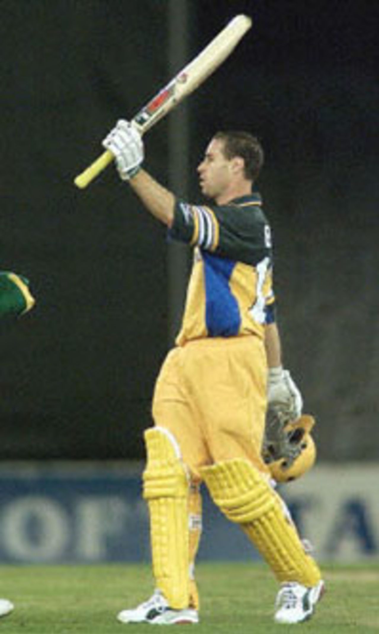 Australian batsman Michael Bevan acknowledges the crowds applause after scoring a century in the first one day cricket match in history to be played under a closed roof at the Colonial Stadium, as Australia takes on South Africa in Melbourne. Being played in the middle of winter in Melbourne, Australia scored 295-5 in their 50 overs with captain Steve Waugh scoring 114 not out and Bevan 106. South Africa in Australia, 2000/01, 1st One-Day International, Australia v South Africa, Colonial Stadium, Melbourne, 16 August 2000.
