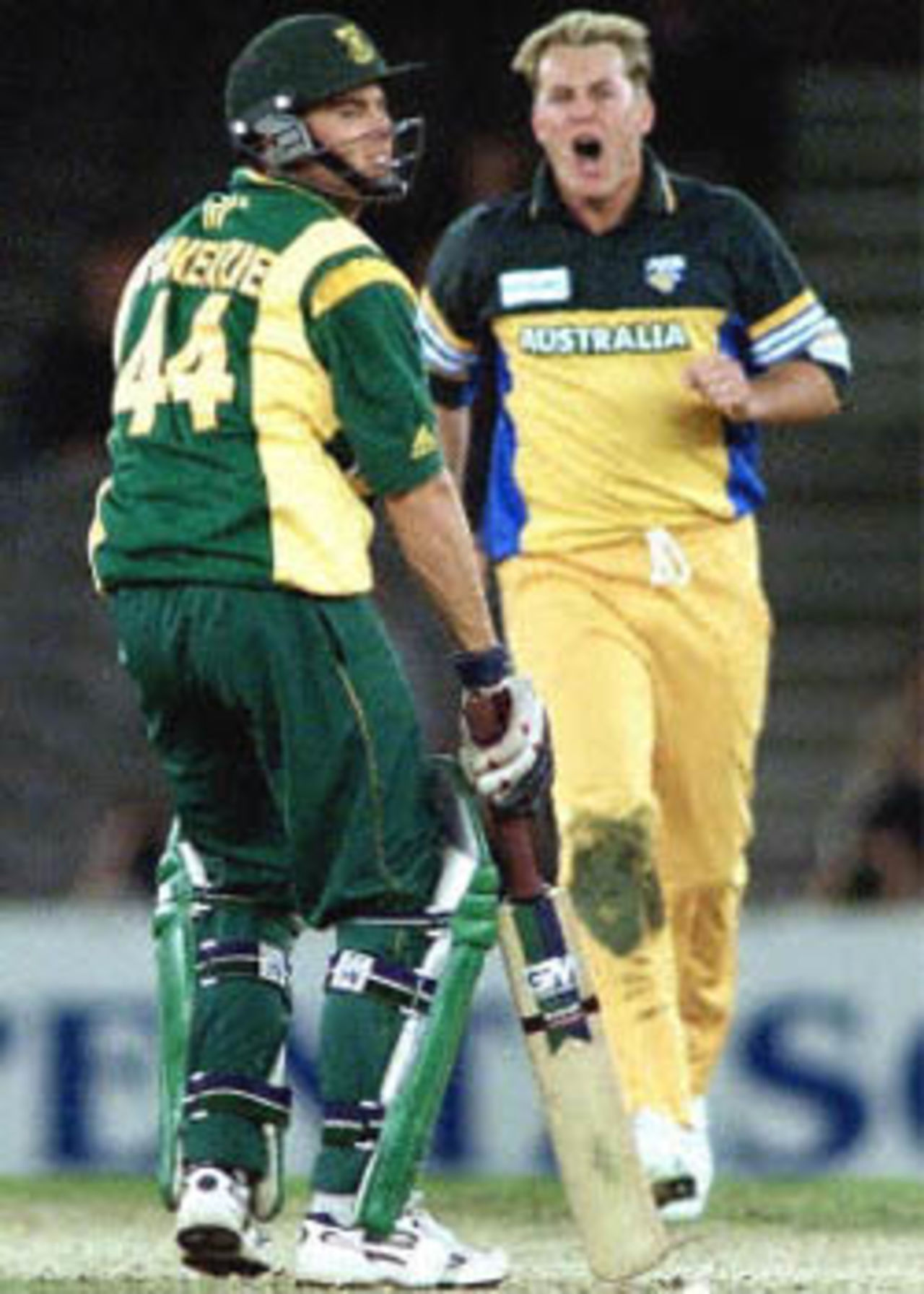 Australian bowler Shane Lee (R) gives South Africa's Neil McKenzie (L) a send off after bowling him in the first one day cricket match in history to be played under a closed roof at Colonial Stadium as Australia takes on South Africa in Melbourne. Being played in the middle of winter in Melbourne, Australia scored 295-5 in their 50 overs and restricted South Africa to 201-7 in their 50 overs to win the match comfortably. South Africa in Australia, 2000/01, 1st One-Day International, Australia v South Africa, Colonial Stadium, Melbourne, 16 August 2000.