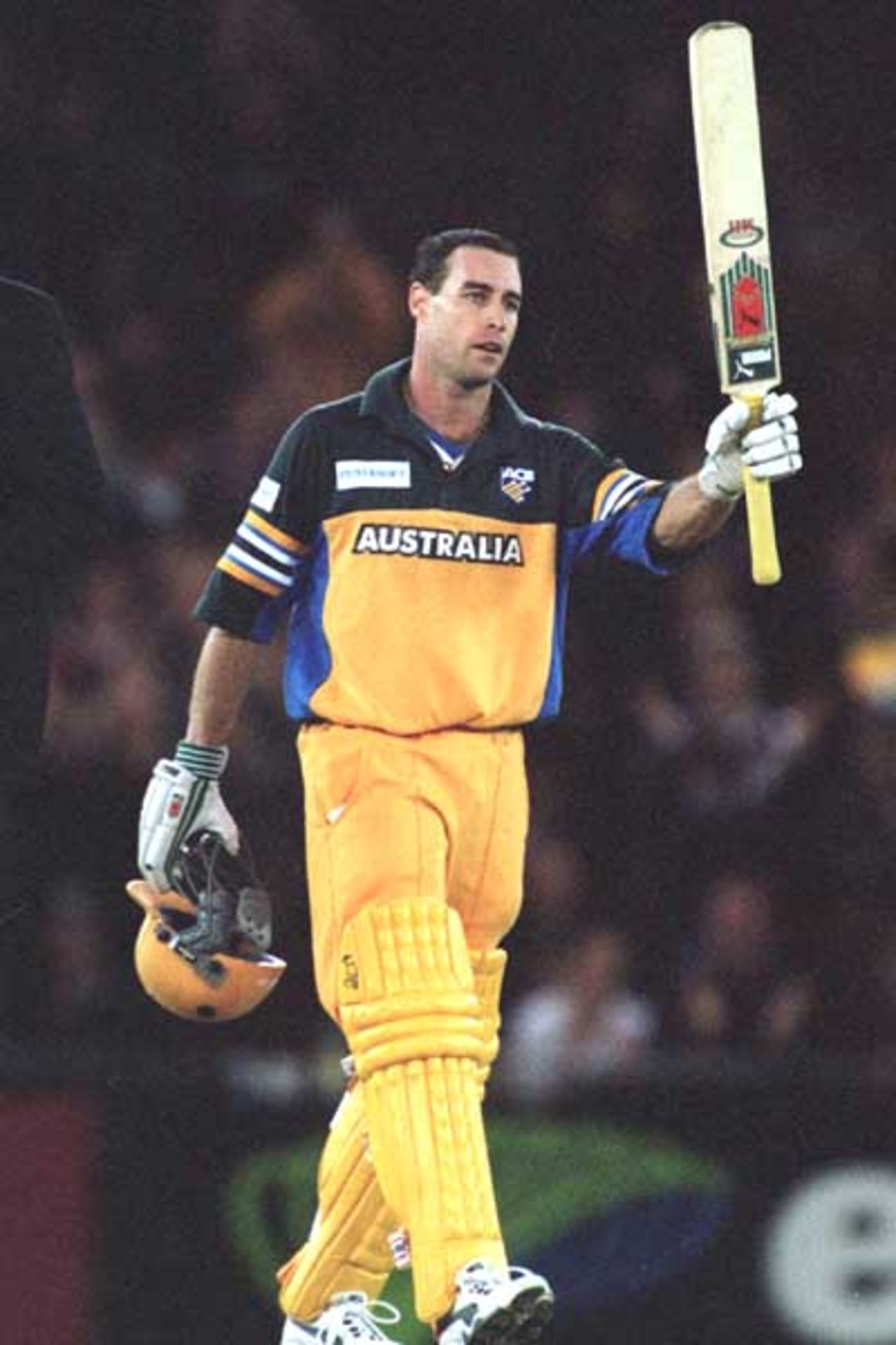 16 Aug 2000: Micheal Bevan waves to the crowd, after scoring a century, during game one of the Super Challenge 2000 between Australia and South Africa, played at Colonial Stadium in Melbourne, Australia. This is the first game of cricket to be played indoors.