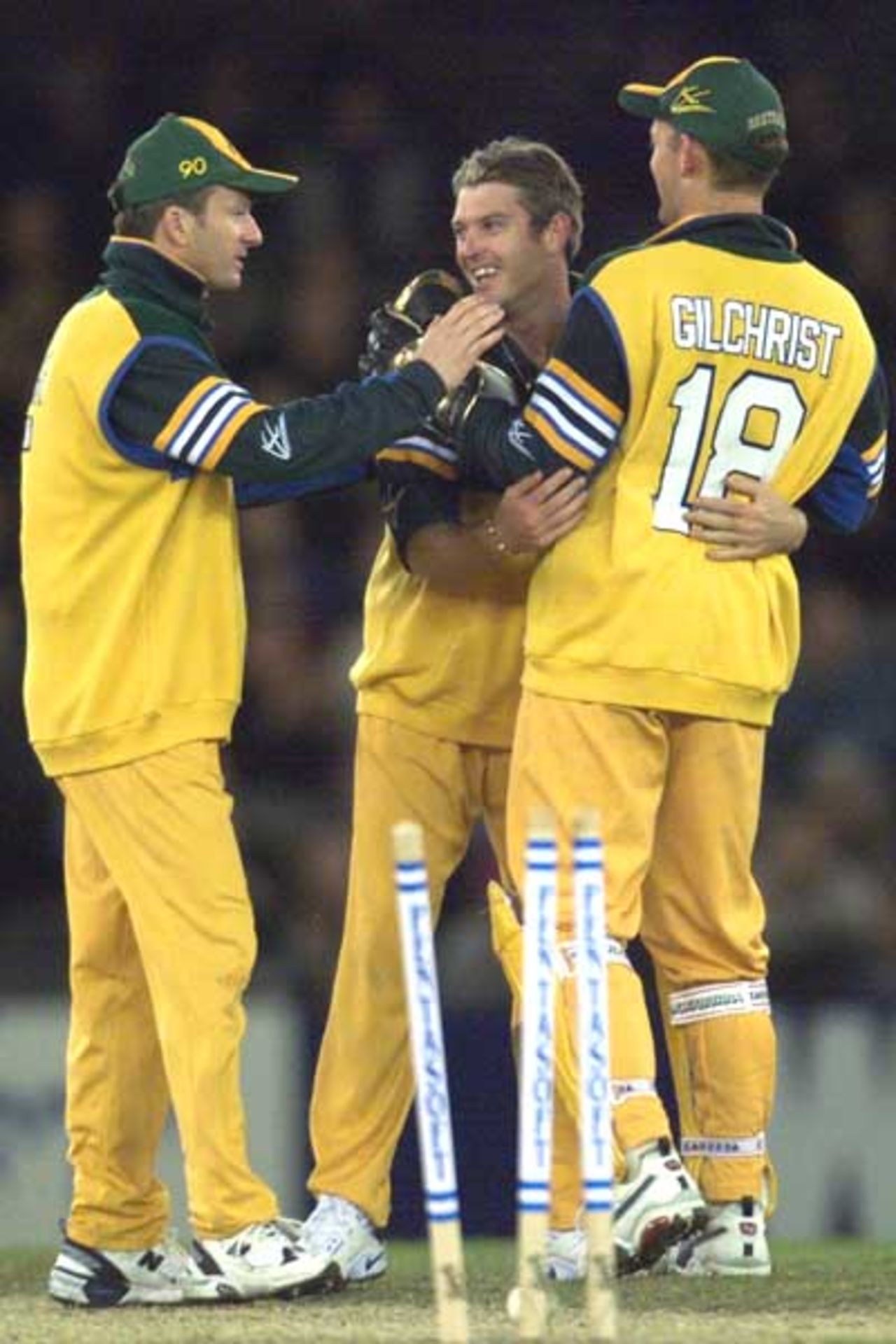 16 Aug 2000: Ian Harvey of Australia is congratulated by team mates Steve Waugh and Adam Gilchrist after taking a wicket, in the match between Australia and South Africa, in game one of the Super Challenge 2000, played at Colonial Stadium in Melbourne, Australia. This is the first game of cricket to be played indoors.