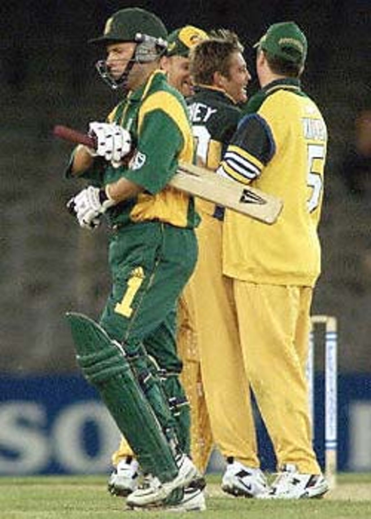 South African batsman Gary Kirsten (L) leaves the wicket after been dismissed by Australian bowler Ian Harvey (2/R) as captain Steve Waugh (R) and Adam Gilchrist (2/L) congratulate Harvey in their one day cricket match being played under a closed roof at the Colonial Stadium in Melbourne. Being played in the middle of winter in Melbourne, South Africa is 129-4 in the 33rd over but Australia leads the three match series 1-0. South Africa in Australia, 2000/01, 2nd One-Day International, Australia v South Africa, Colonial Stadium, Melbourne, 18 August 2000.
