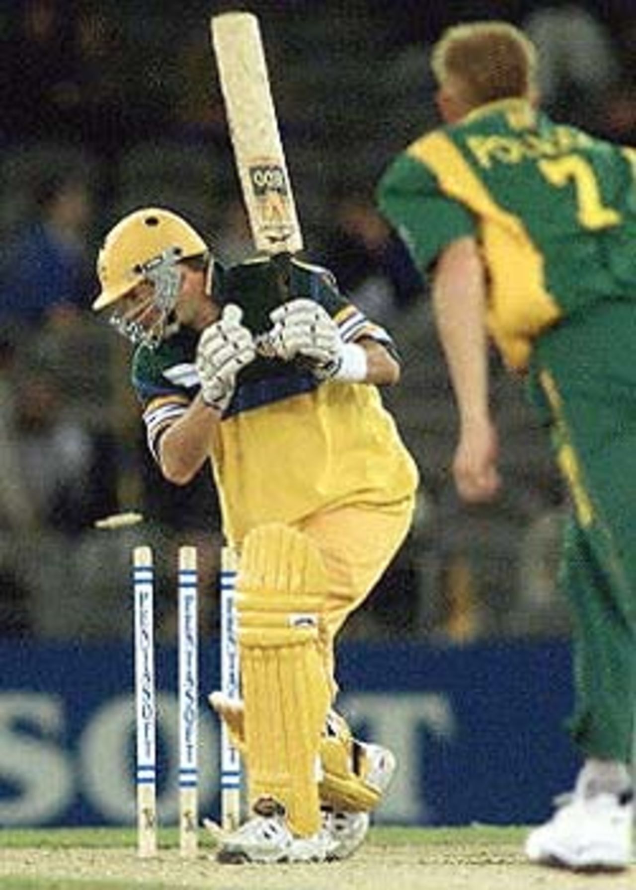 Australian batsman Mark Waugh (L) is bowled by South African captain Shaun Pollock in their one-day cricket match being played under a closed roof at the Colonial Stadium in Melbourne. Being played in the middle of winter in Melbourne, South Africa scored 206-7 from their 50 overs d Australia is 171-6 in reply after 43 overs. South Africa in Australia, 2000/01, 3rd One-Day International, Australia v South Africa, Colonial Stadium, Melbourne, 20 August 2000.