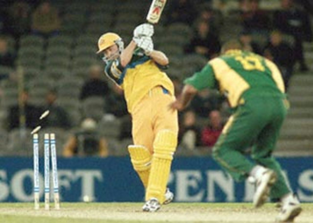 Australian batsman Damien Martyn (L) is bowled by South African bowler Roger Telemachus in their one-day cricket match being played under a closed roof at the Colonial Stadium in Melbourne. Being played in the middle of winter in Melbourne, South Africa scored 206-7 from their 50 overs and restricted Australia to 198-9 to draw the three match series 1-1 with one game tied. South Africa in Australia, 2000/01, 3rd One-Day International, Australia v South Africa, Colonial Stadium, Melbourne, 20 August 2000.
