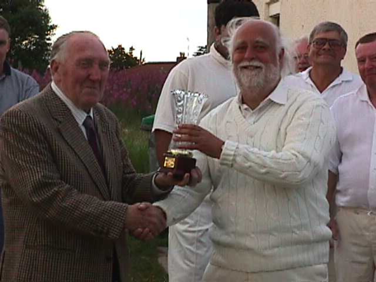 League President Jack Hartley presents Accrington 4th XI captain Ian Ormerod with the trophy