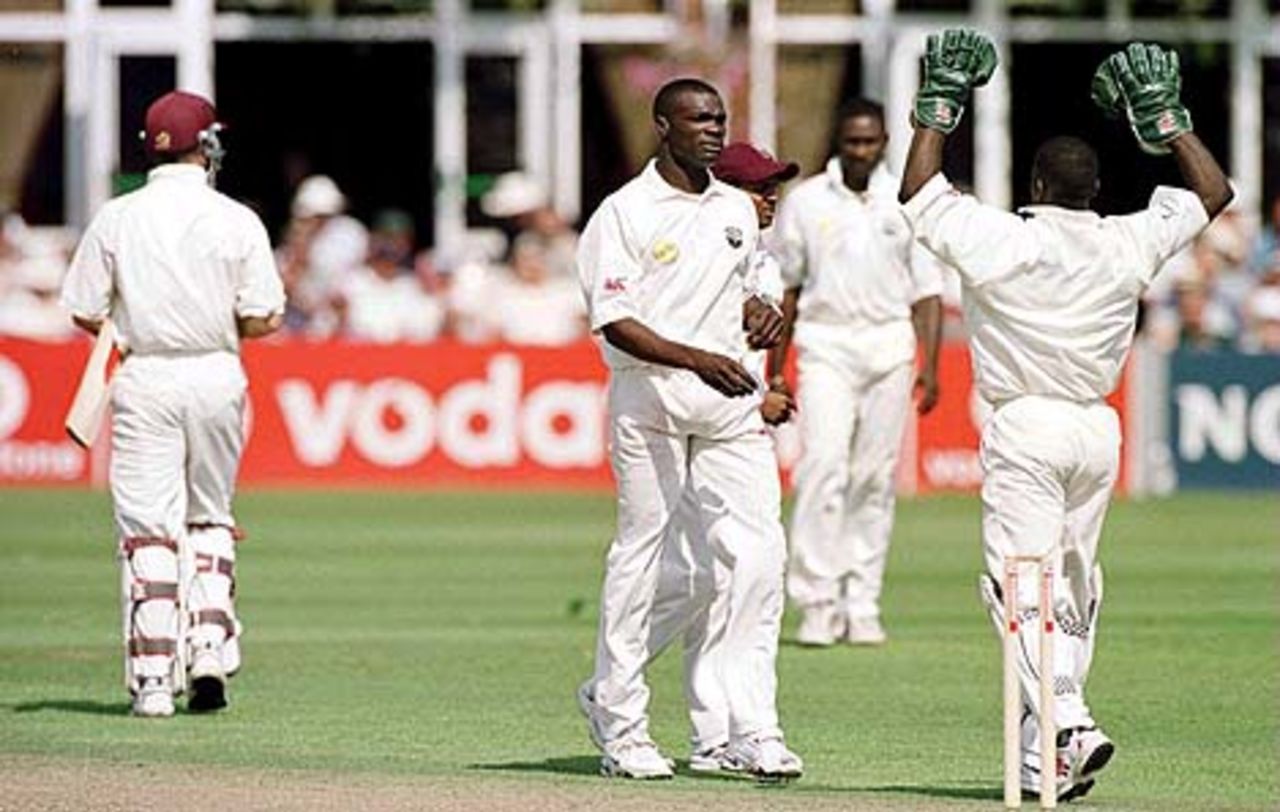 23 Aug 2000: Reon King celebrates with wicketkeeper Ridley Jacobs of the West Indies after taking the wicket of Jamie Cox of Somerset during the Somerset v West Indies Vodafone Challenge match at Taunton, Somerset.