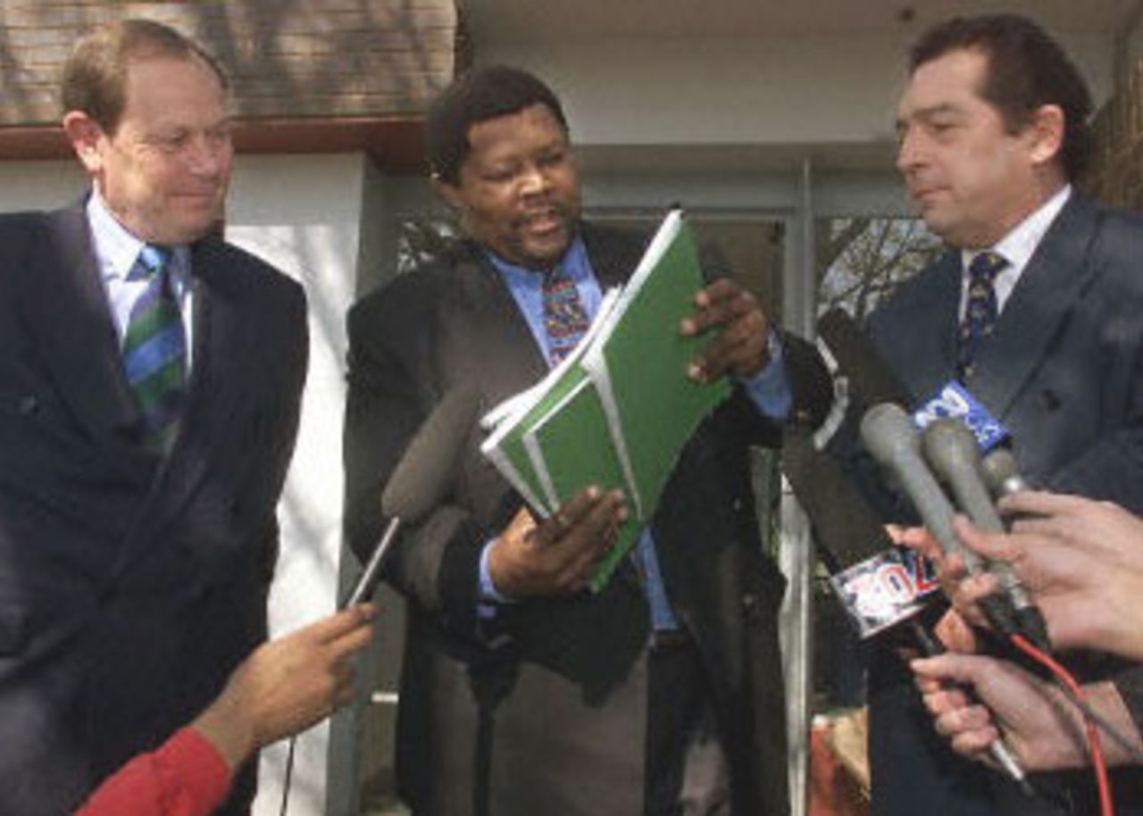 South African sportminister Ngconde Balfour (C) hands the King Commission South African sportminister Ngconde Balfour (C) hands the King Commission interim report on alleged match fixing in cricket to South African United Cricket board President Dr. Ali Bacher (L) and the executive of the International Cricket Commission David Richards (R) in Johannesburg, 24 August 2000. The inquiry into match fixing in South African cricket got under way after former South African cricket captain Hansie Cronje revealed he had taken bribes to throw matches.