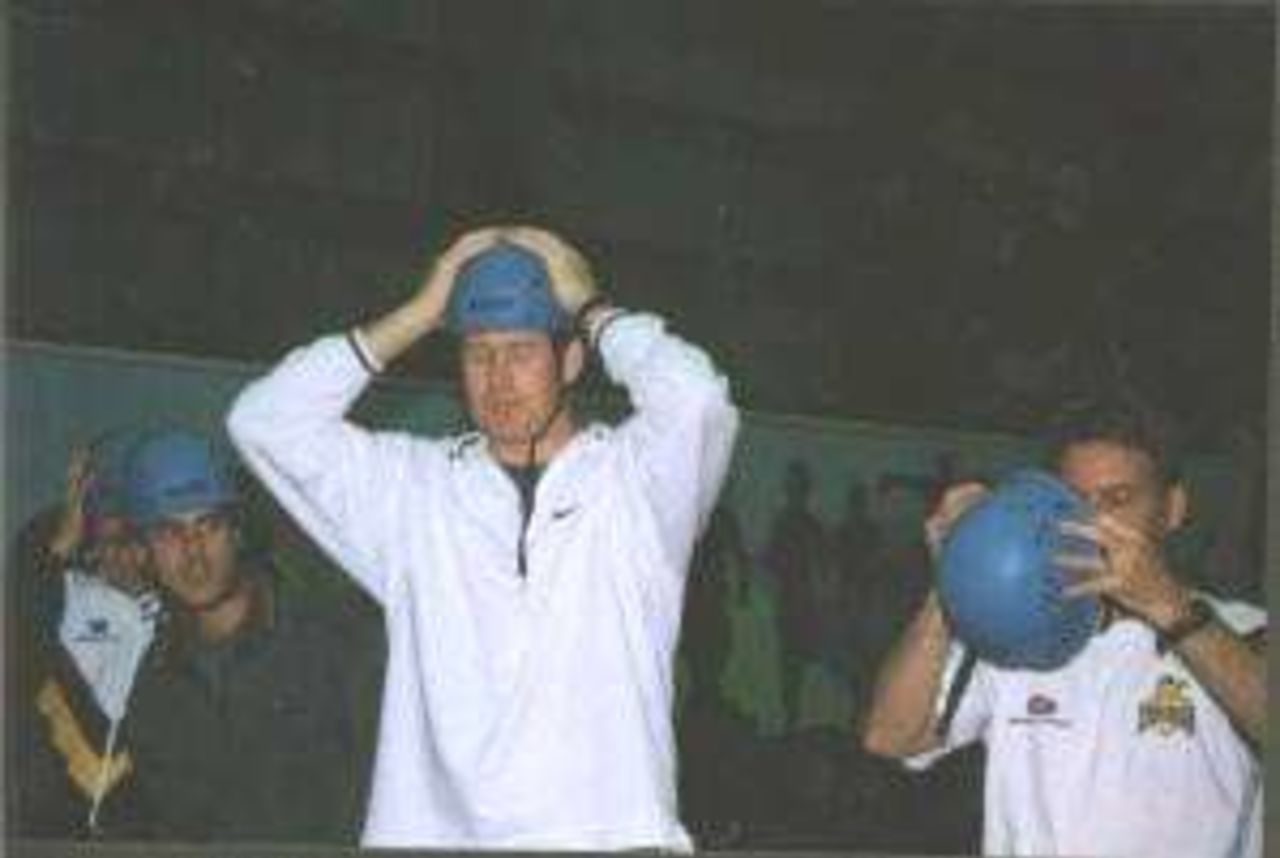 Warriors captain Tom Moody dons a safety helmet before setting off for the climbing wall and the flying fox. Robbie Baker looks on.