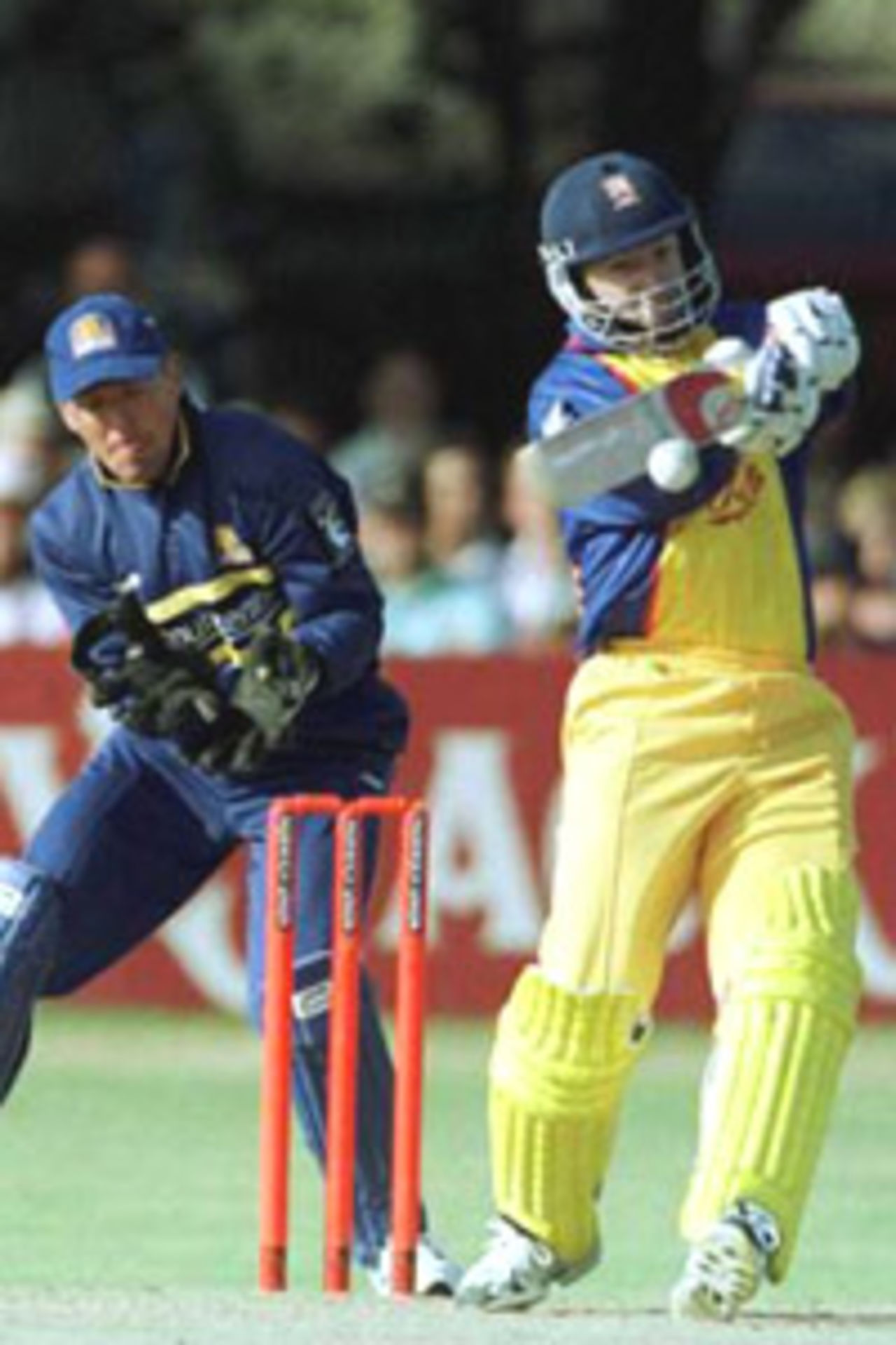 23 August 2000. Stuart Law of Essex in full flow on his way to an innings of 92 with Alec Stewart of Surrey behind the stumps during the Norwich Union NCL Division Two match at Castle Park in Colchester in Essex.