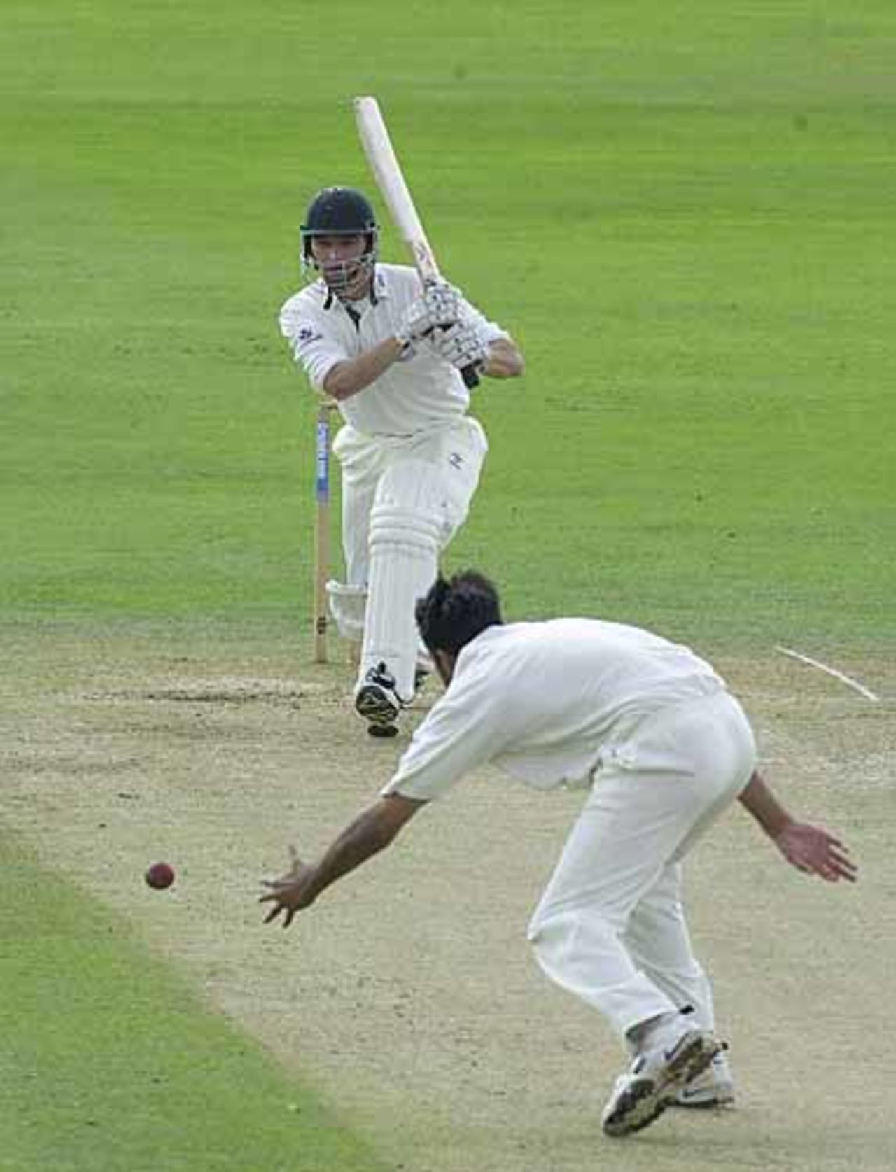 David Leatherdale drives a delivery back past bowler Malik, CricInfo Championship, 9th August 2001