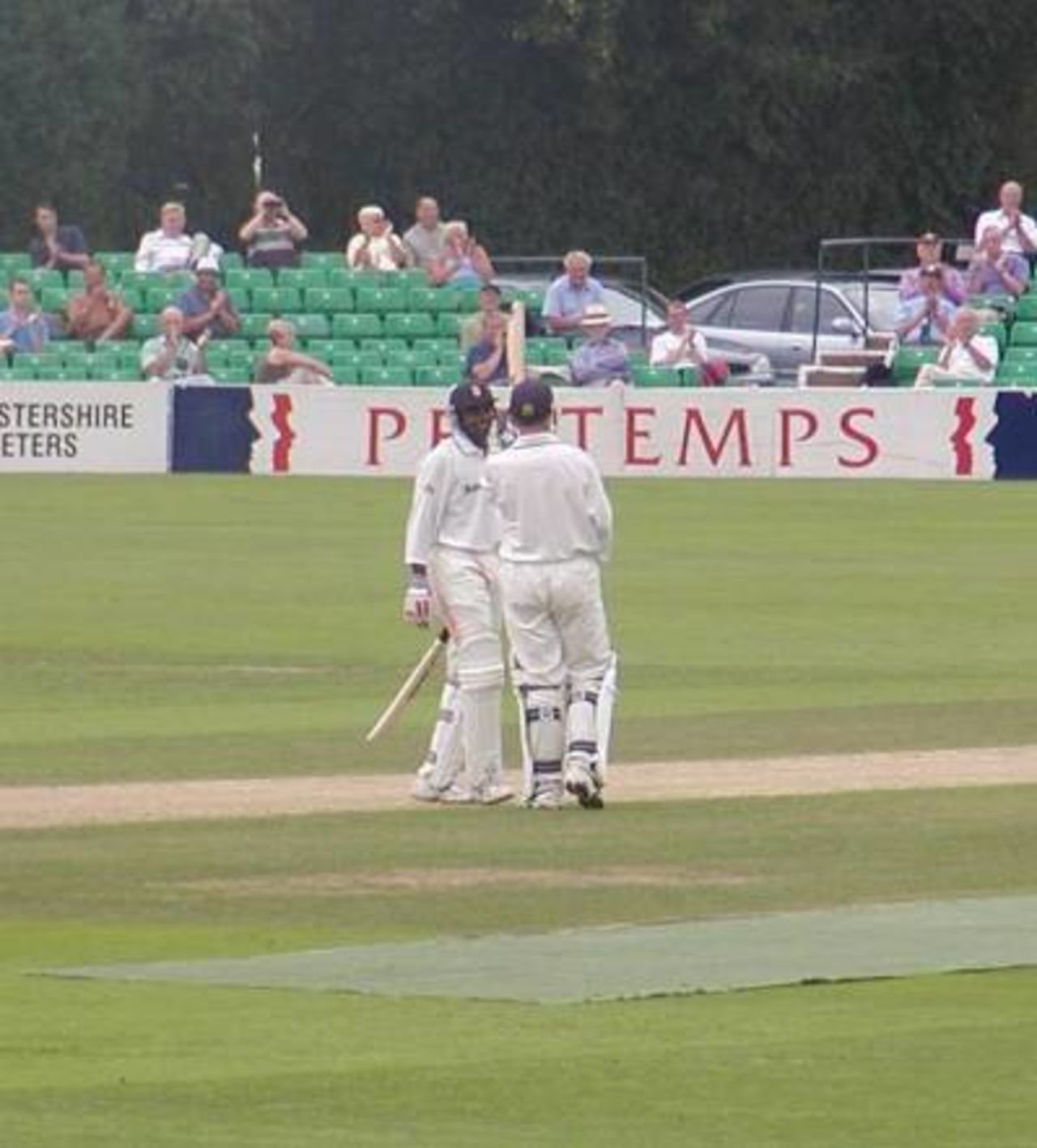 Neil Johnson is congratulated by the smiling Dimitri Mascarenhas after completing his century at Worcester.
