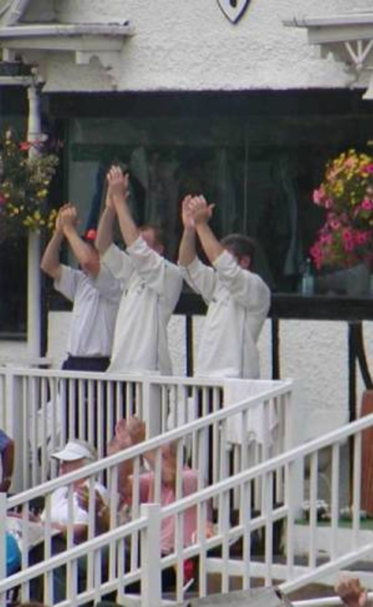 Hampshire players applaud Neil Johnson's century from the balcony at Worcester