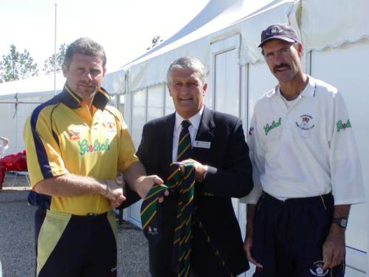 Hampshire captain Robin Smith and Head Coach Jimmy Cook receive the special ties on behalf of the whole team that took part in the special match.