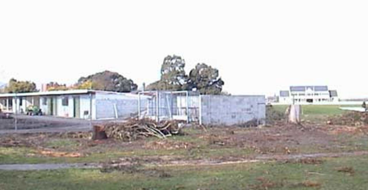 The location of the new New Zealand Cricket High Performance Centre 12-lane outdoor practice net facility, replacing the part of the grounds department buildings at Lincoln University. The Bert Sutcliffe Oval pavilion is in the background. 29 August 2001.