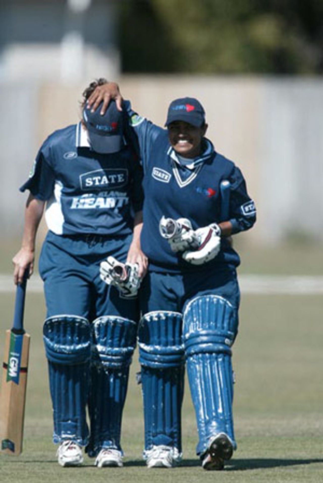 Auckland women's players Helen Watson (left) and Ana Soma leave the field at the end of the match after beating Canterbury by five wickets. State League Final: Canterbury Women v Auckland Women at Redwood Park, Christchurch, 22 February 2003.