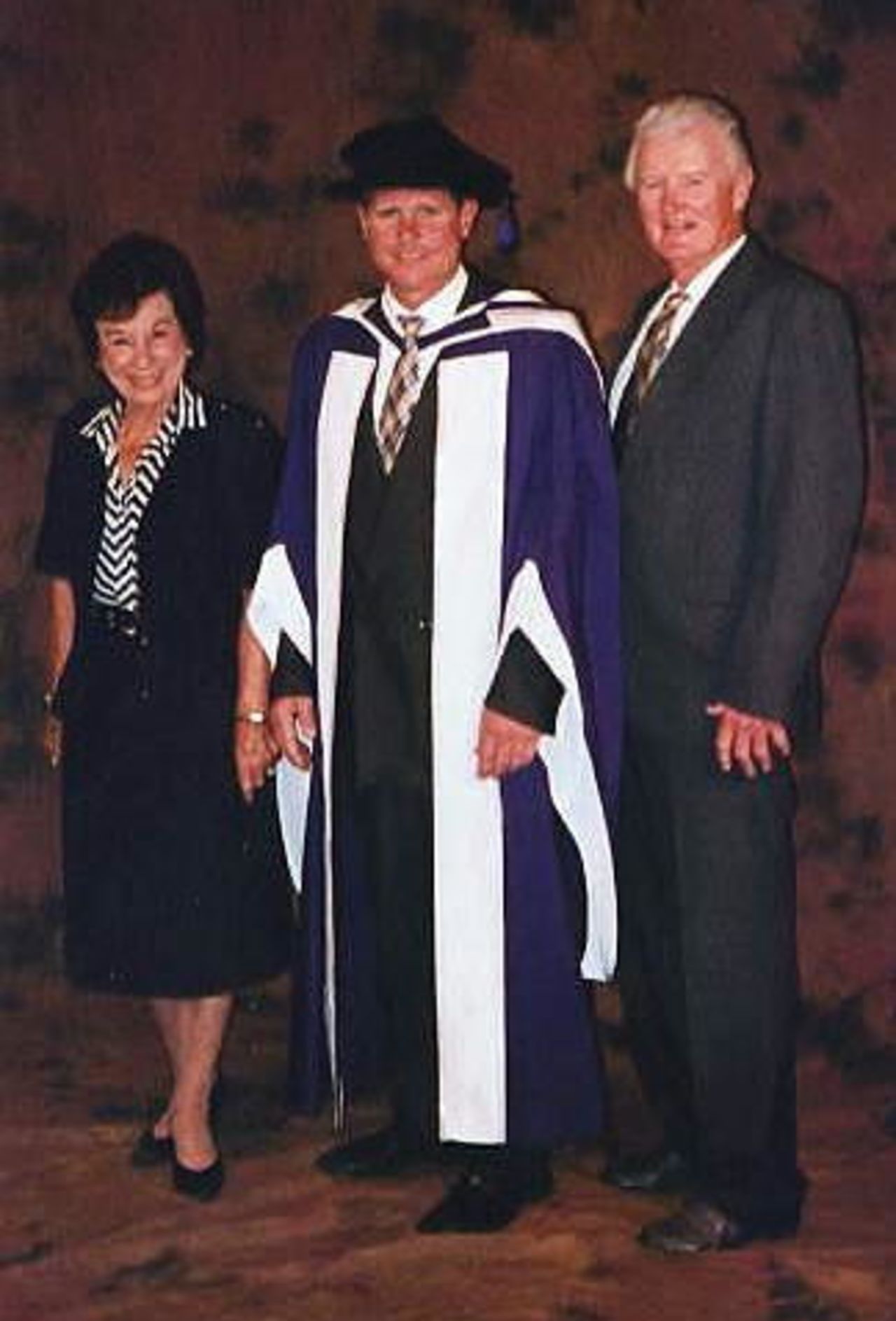Robin Smith robed for his investiture as Doctor of Letters (hon) at Portsmouth University, here seen with mother and father Joy and John