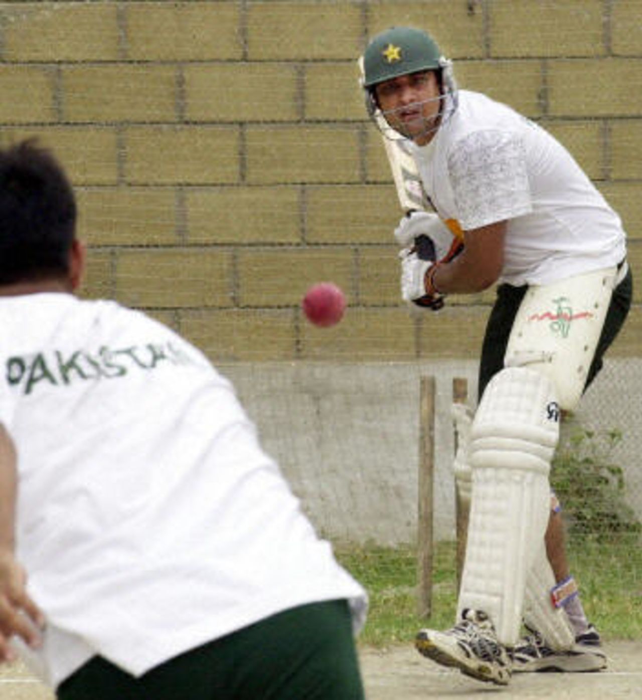 Pakistan cricketer Inzamam-ul-Haq (L) prepares to strike a ball during a net training session at the National Stadium in Karachi, 18 August 2003. The team is preparing for a test match series against Bangladesh which will commence on 20 August.