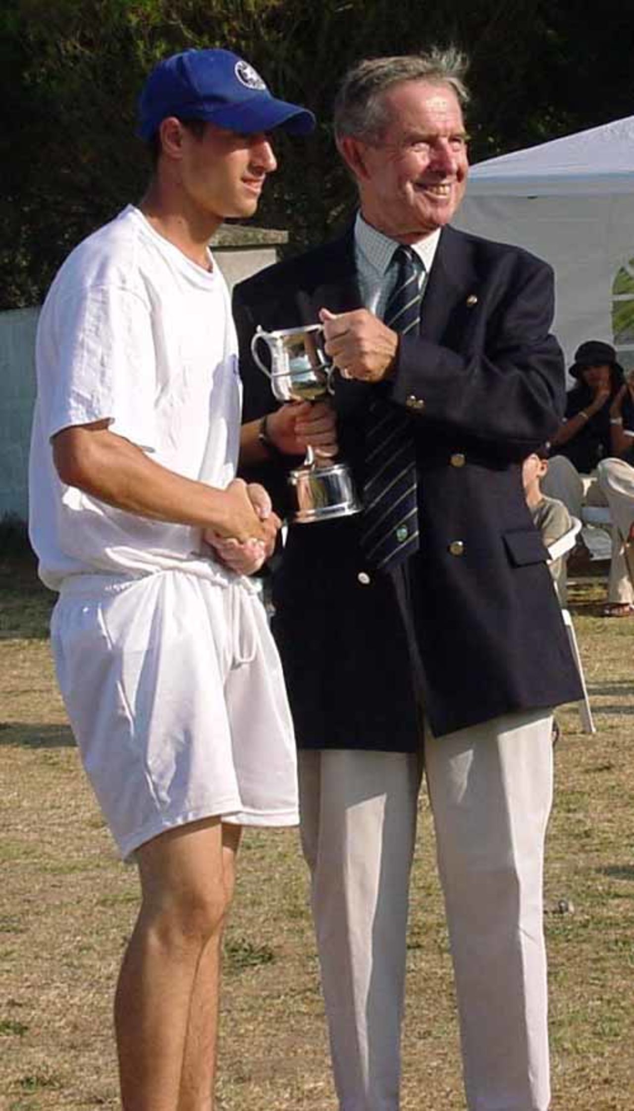 Israel captain Danny Hotz is presented with the ECC 2nd Division U15 trophy by the tournament director.