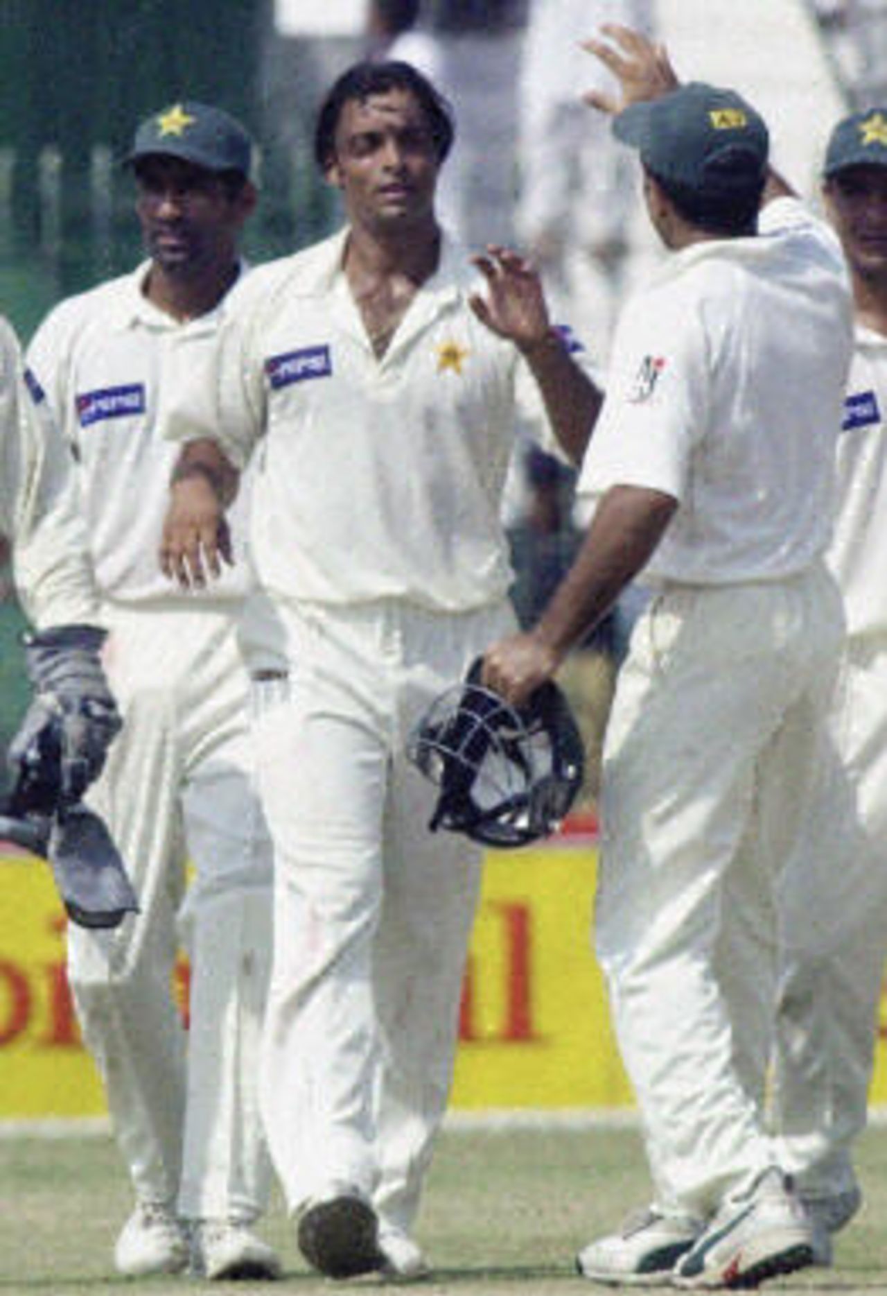 Shoaib Akhtar (C) celebrates his sixth wicket with his teammates on the second day of the second Test between Pakistan and Bangladesh in Peshawar, 28 August 2003