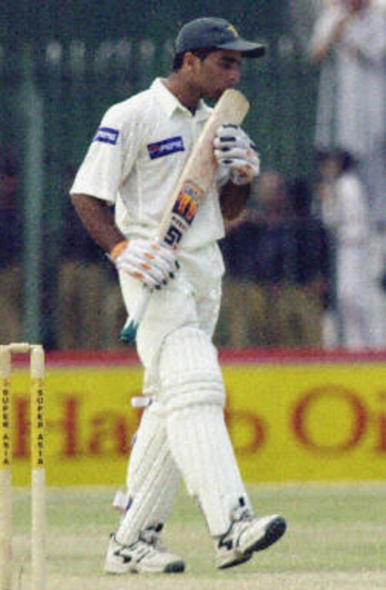 Taufeeq Umar kisses his bat after scoring a half century on the second day of the second Test between Pakistan and Bangladesh in Peshawar, 28 August 2003.
