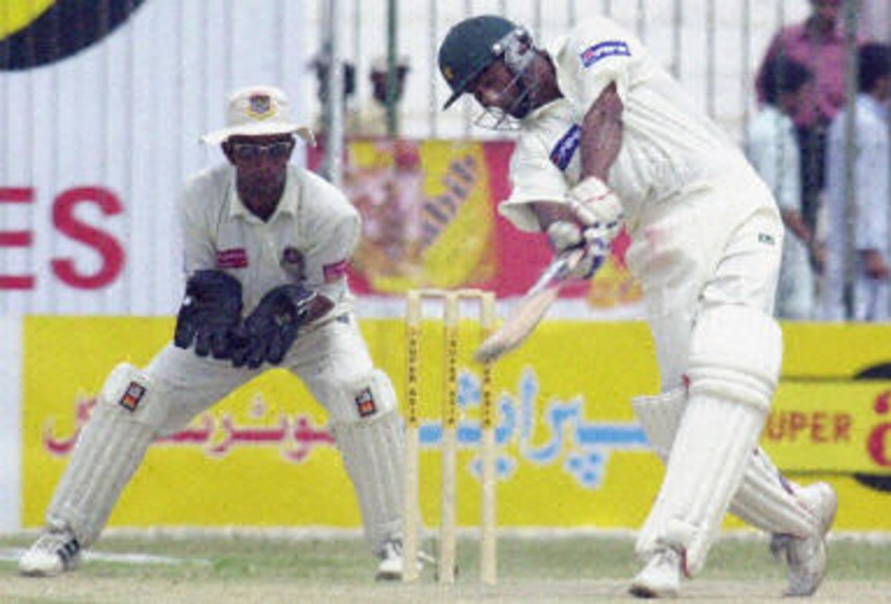 Yousuf Youhana (R) hits a ball as Khaled Mashud (L) looks on during the third day of the second Test between Pakistan and Bangladesh in Peshawar, 29 August 2003.