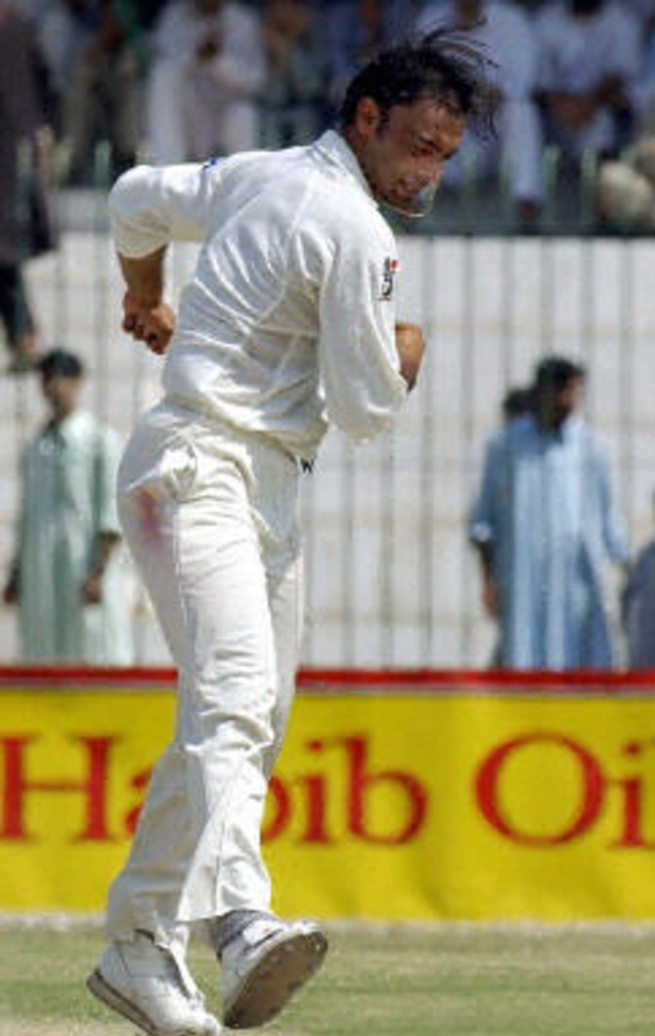 Shoaib Akhtar celebrates dismissing Rajin Saleh (not in the picture) after completing his 100 Test wickets on the fourth day of the second Test between Pakistan and Bangladesh in Peshawar, 30 August 2003.