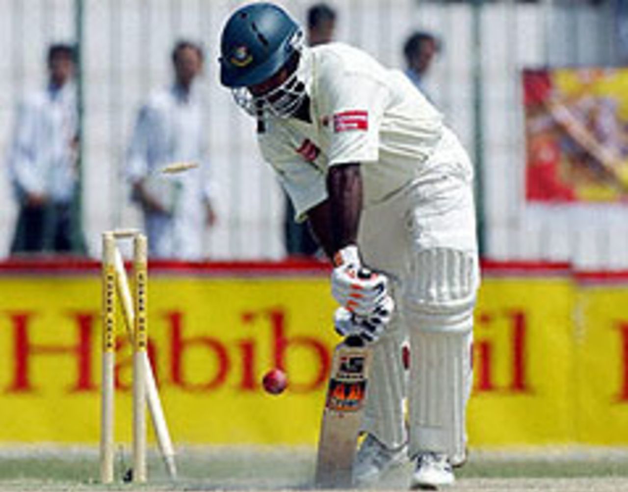 Bangladesh's Alamgir Kabir is bowled by Umar Gul, as Pakistan resume command