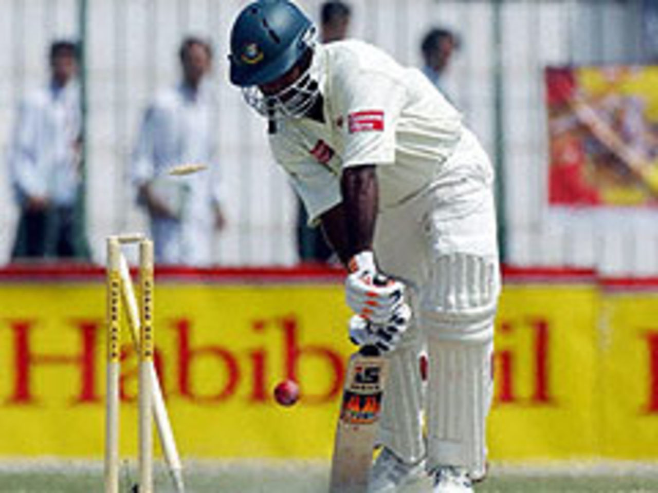 Bangladesh's Alamgir Kabir is bowled by Umar Gul, as Pakistan resume command
