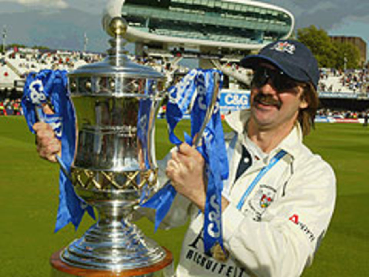 Jack Russell parades the C&G Trophy after Gloucestershire crushed Worcestershire at Lord's