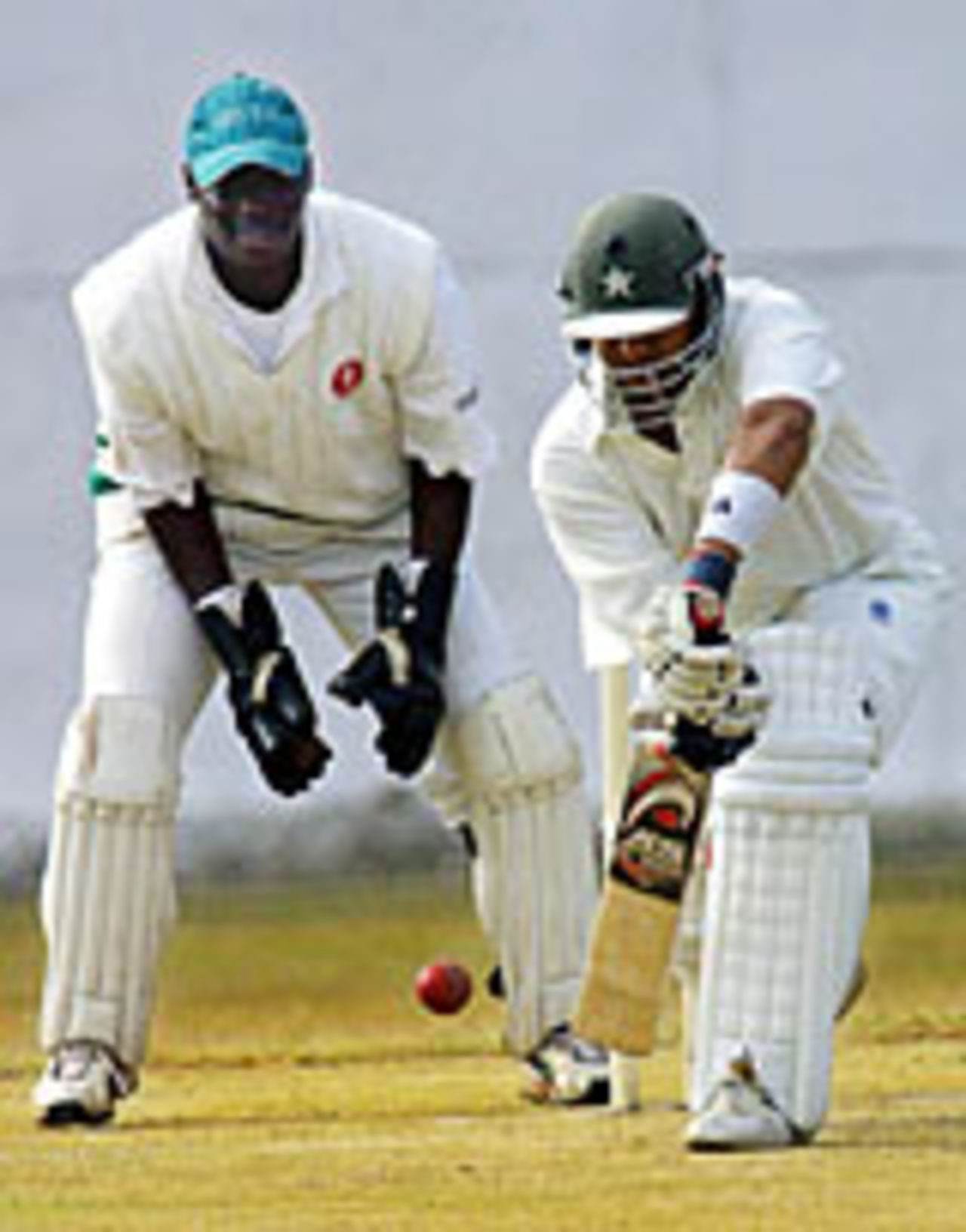 Faisal Iqbal plays defensively, watched by Kennedy Obuya, Kenya v Pakistan A, Simba Union, July 31, 2004
