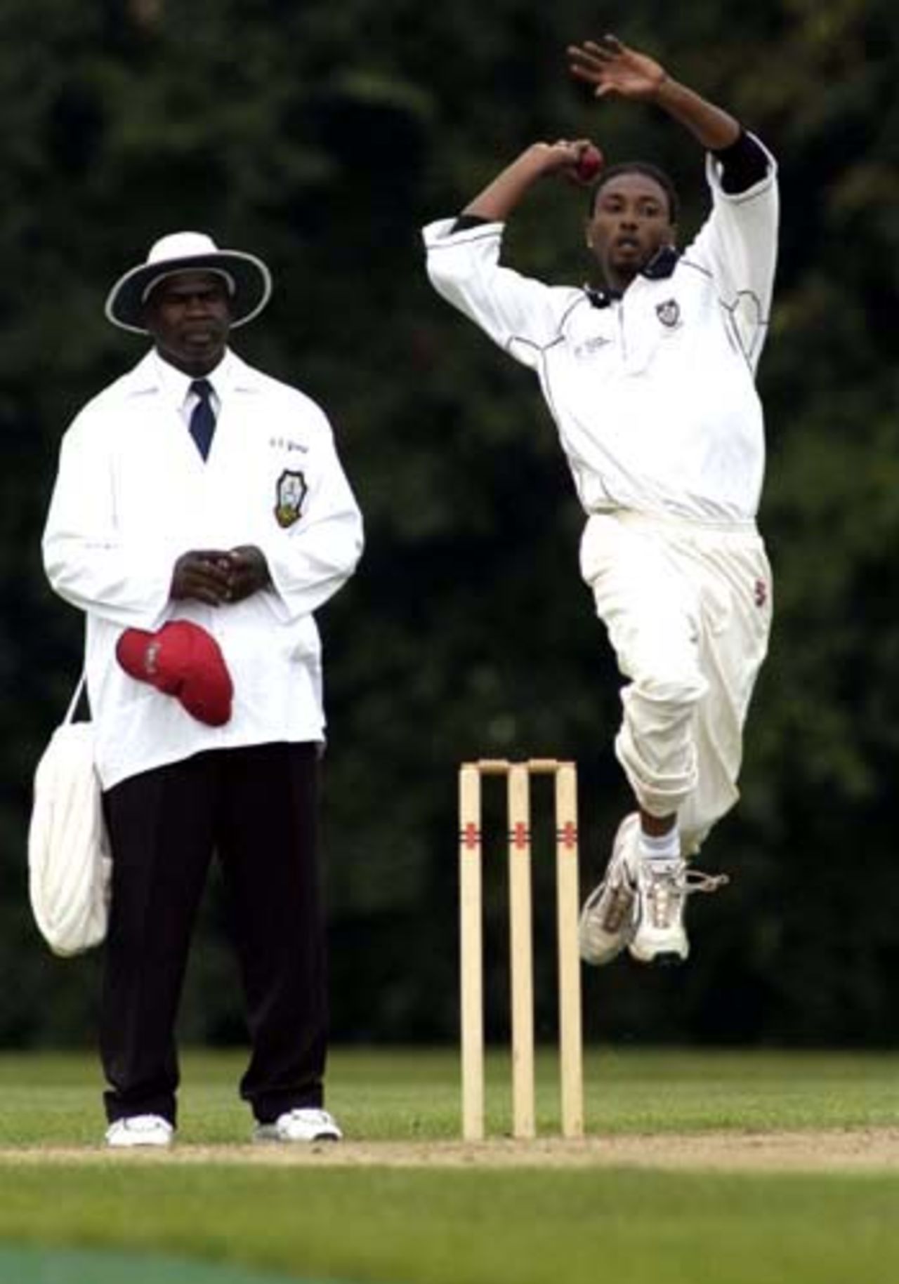 Austin Codrington in action, Umpire is Courtney Young (Cayman Islands)