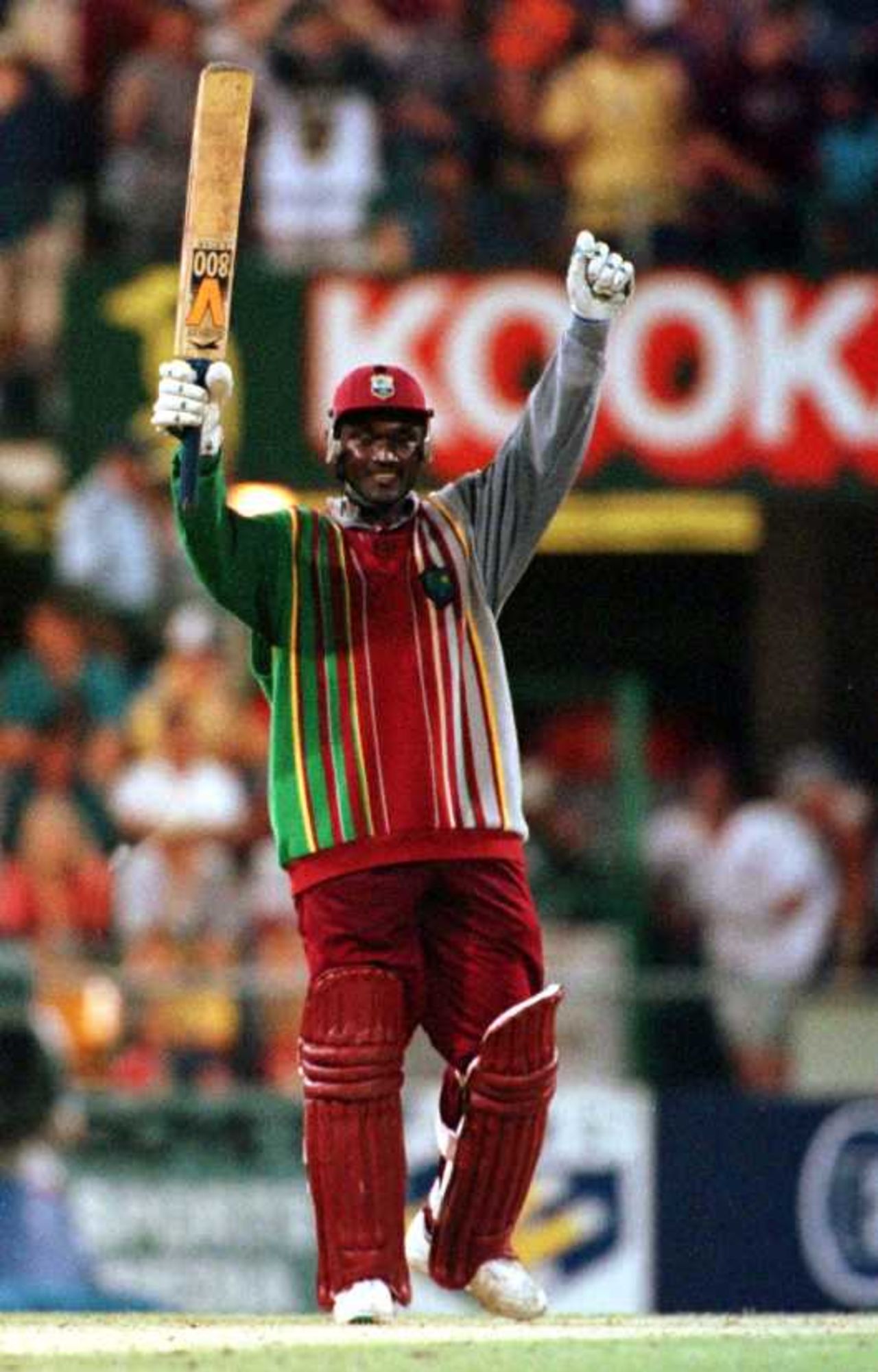 Carl Hooper acknowledges the crowd as he reaches his 100 against