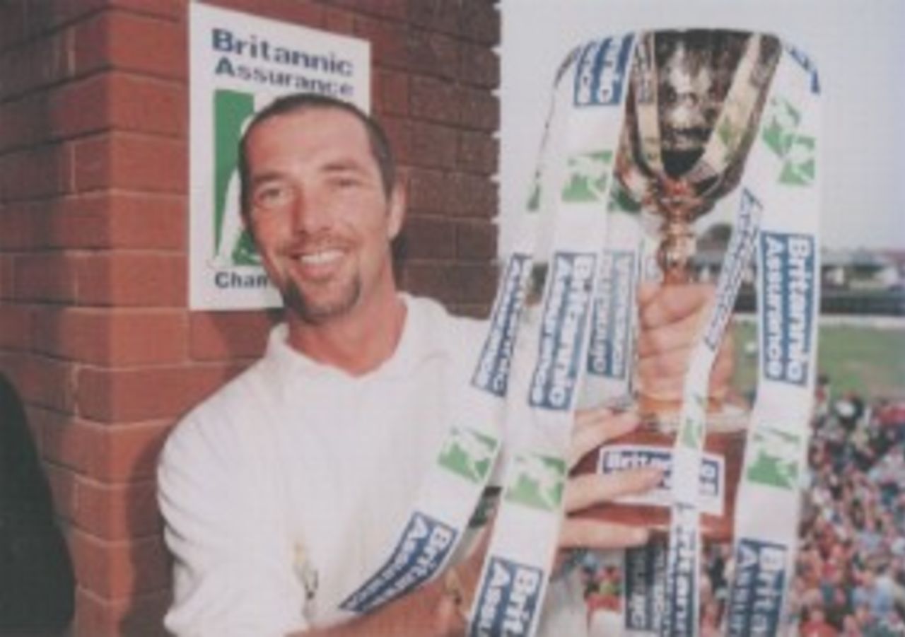 Matthew Maynard holds the Championship Trophy