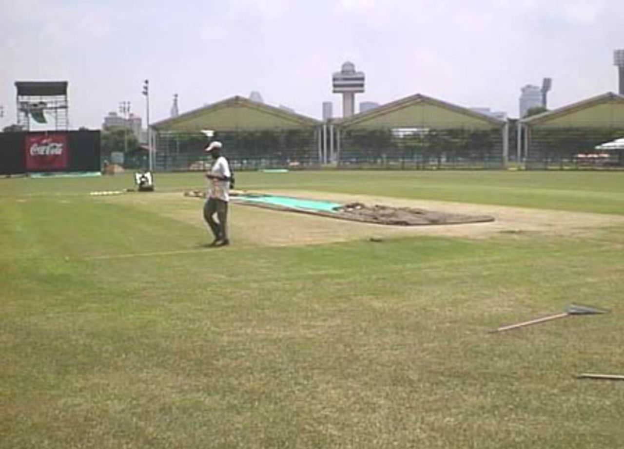 Groundsmen preparing the pitch at the Kallang ground