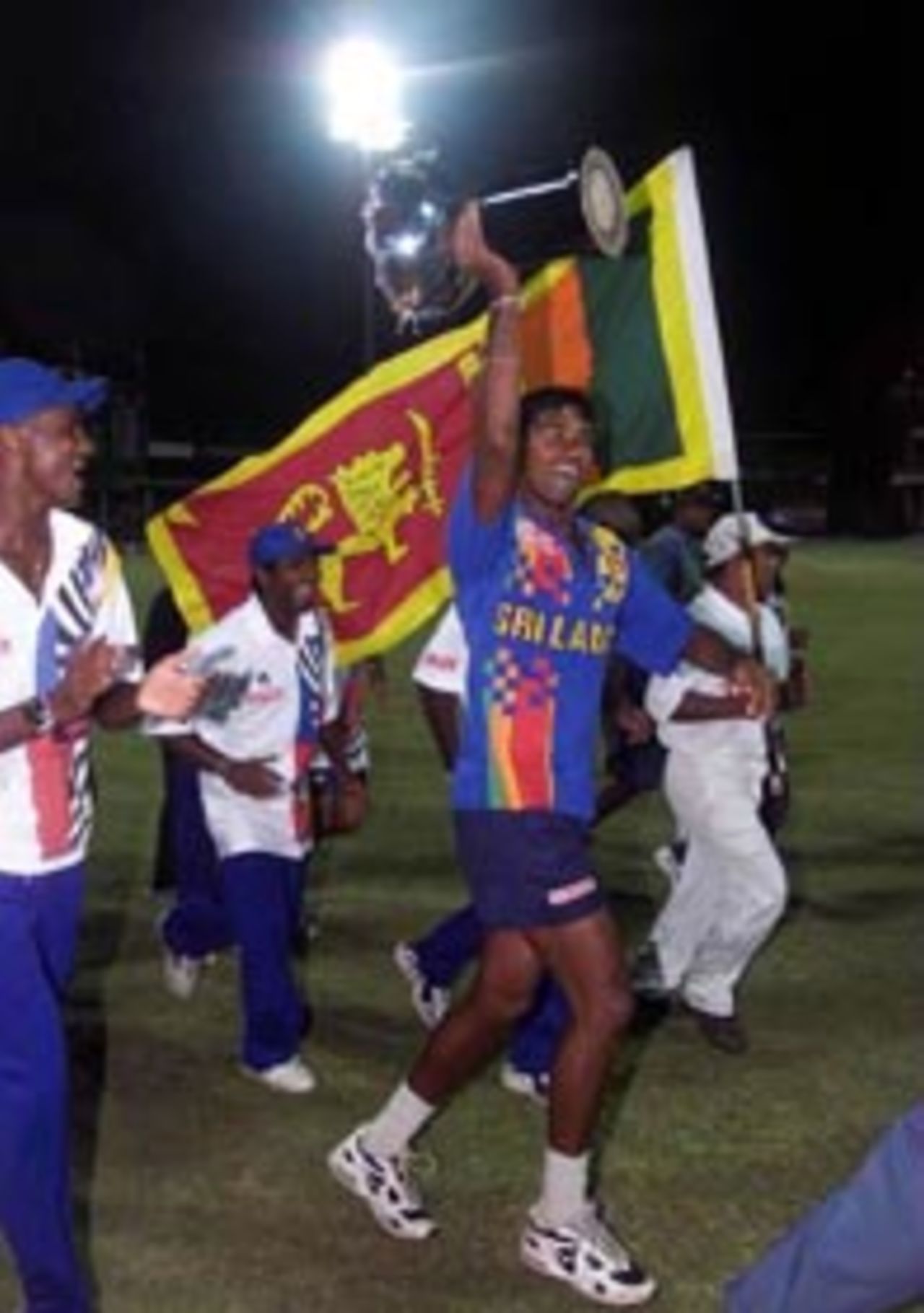 31 August 1999: Pramodya Wickremakinghe of Sri Lanka holds the AIWA cup aloft, as the Sri Lankan team run a lap of honour after the one day Final at Premadasa Stadium, Colombo, Sri Lanka. Sri Lanka won by eight wickets.