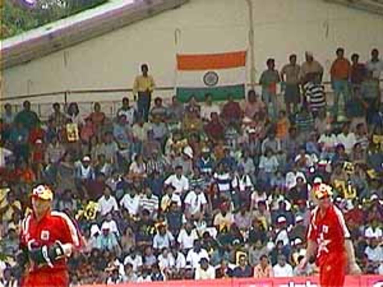 Section of the crowd watching the India-Zimbabwe match. Andy Flower and Alistair Campbell in the foreground, India v Zimbabwe (2nd ODI), Coca-Cola Singapore Challenge, 1999-2000, Kallang Ground, Singapore, 4 Sep 1999.