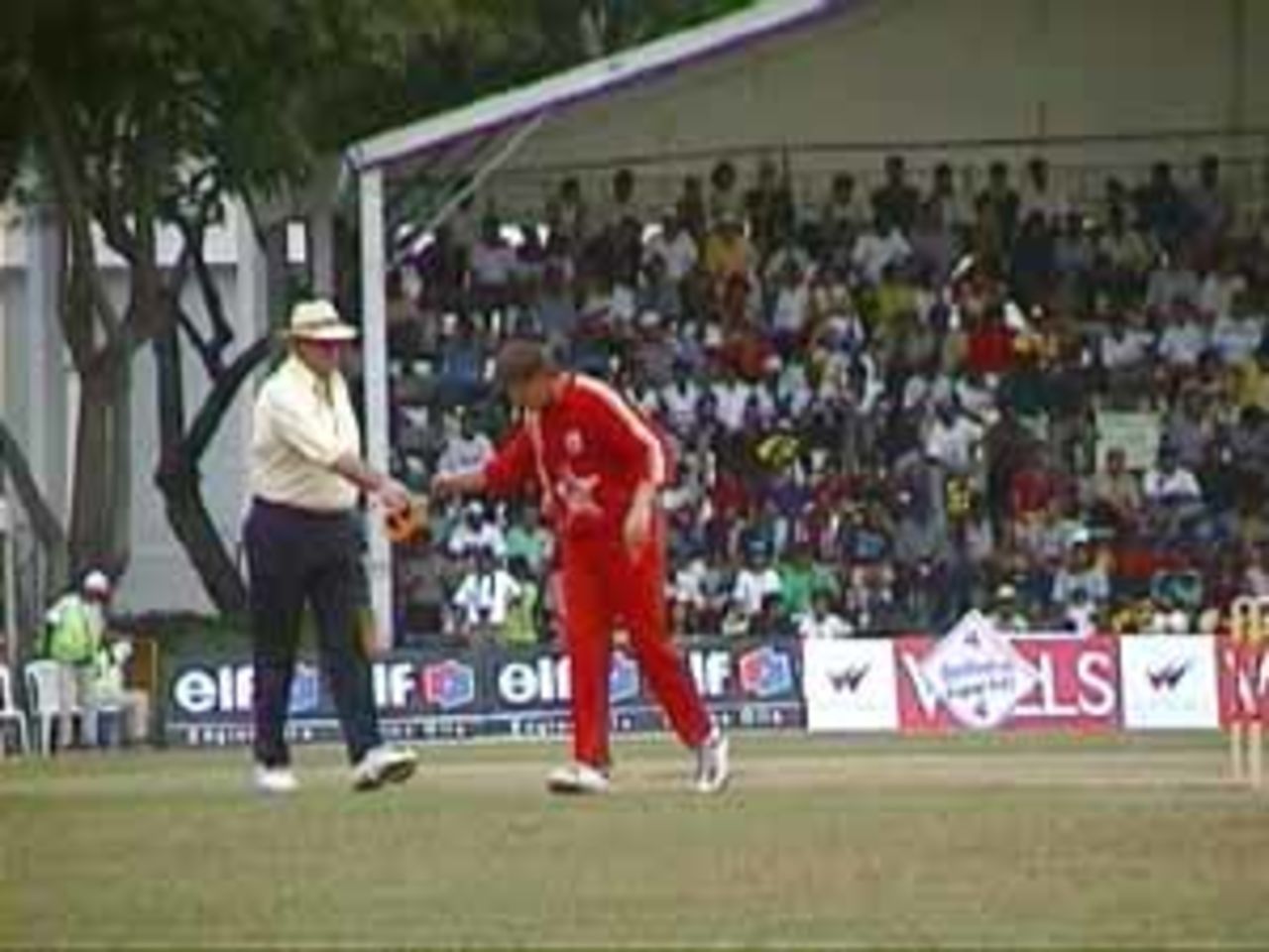 Hair hands over the cap to a much relieved Zimbabwean bowler, India v Zimbabwe (2nd ODI), Coca-Cola Singapore Challenge, 1999-2000, Kallang Ground, Singapore, 4 Sep 1999.
