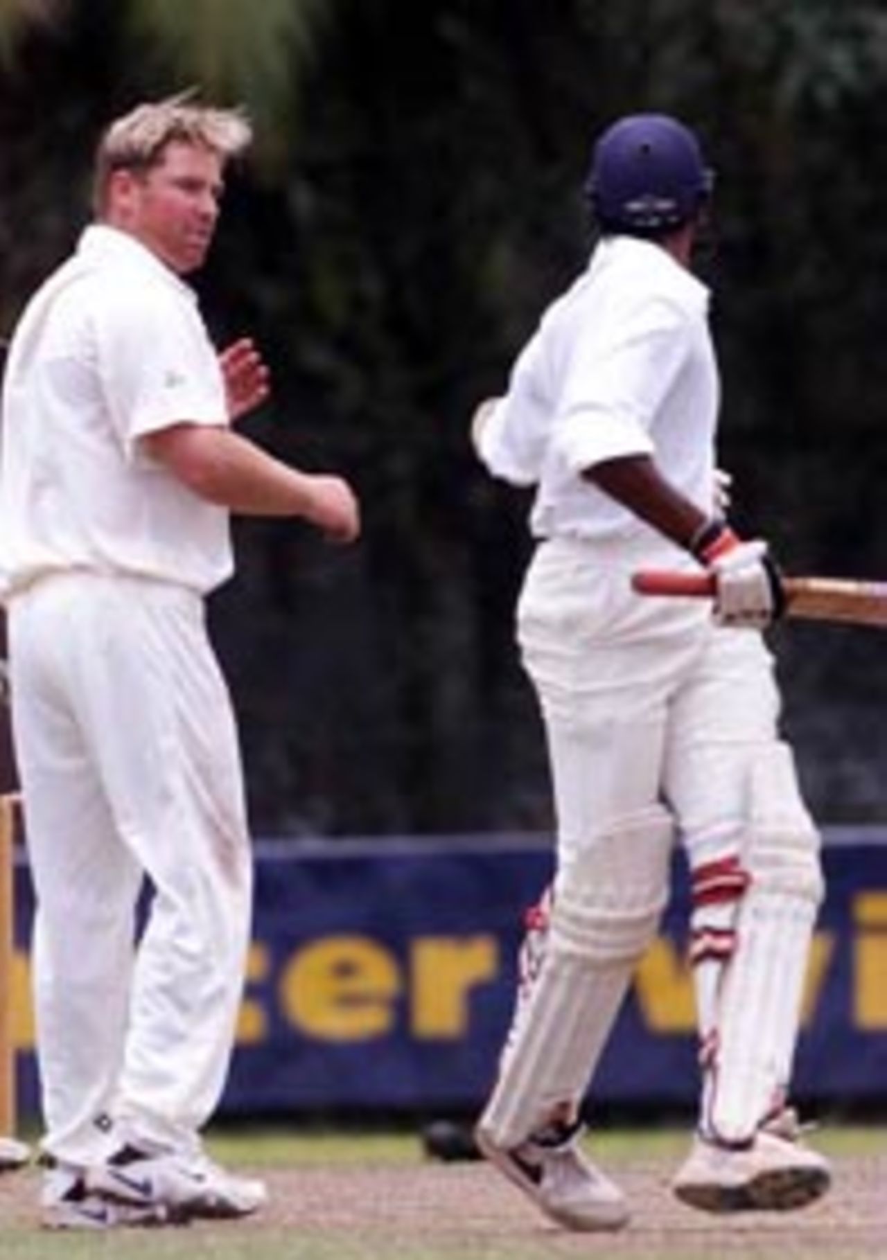 5 Sep 1999: Shane Warne (left) of Australia exchanges words with Pradeep Hewage of the Board XI after they collided mid pitch, during day three of the tour match between the Sri Lanka Board XI and Australia at Saravanamuttu Stadium, Colombo, Sri Lanka.