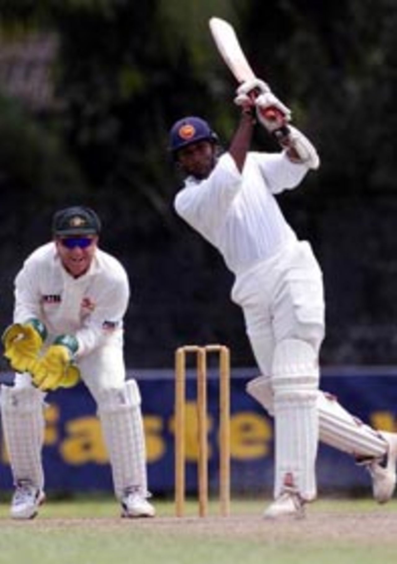 4 Sep 1999: Pradeep Hewage of the Board XI on the attack with Ian Healy of Australia looking on, during day three of the tour match between the Sri Lanka Board XI and Australia at Saravanamuttu Stadium, Colombo, Sri Lanka.