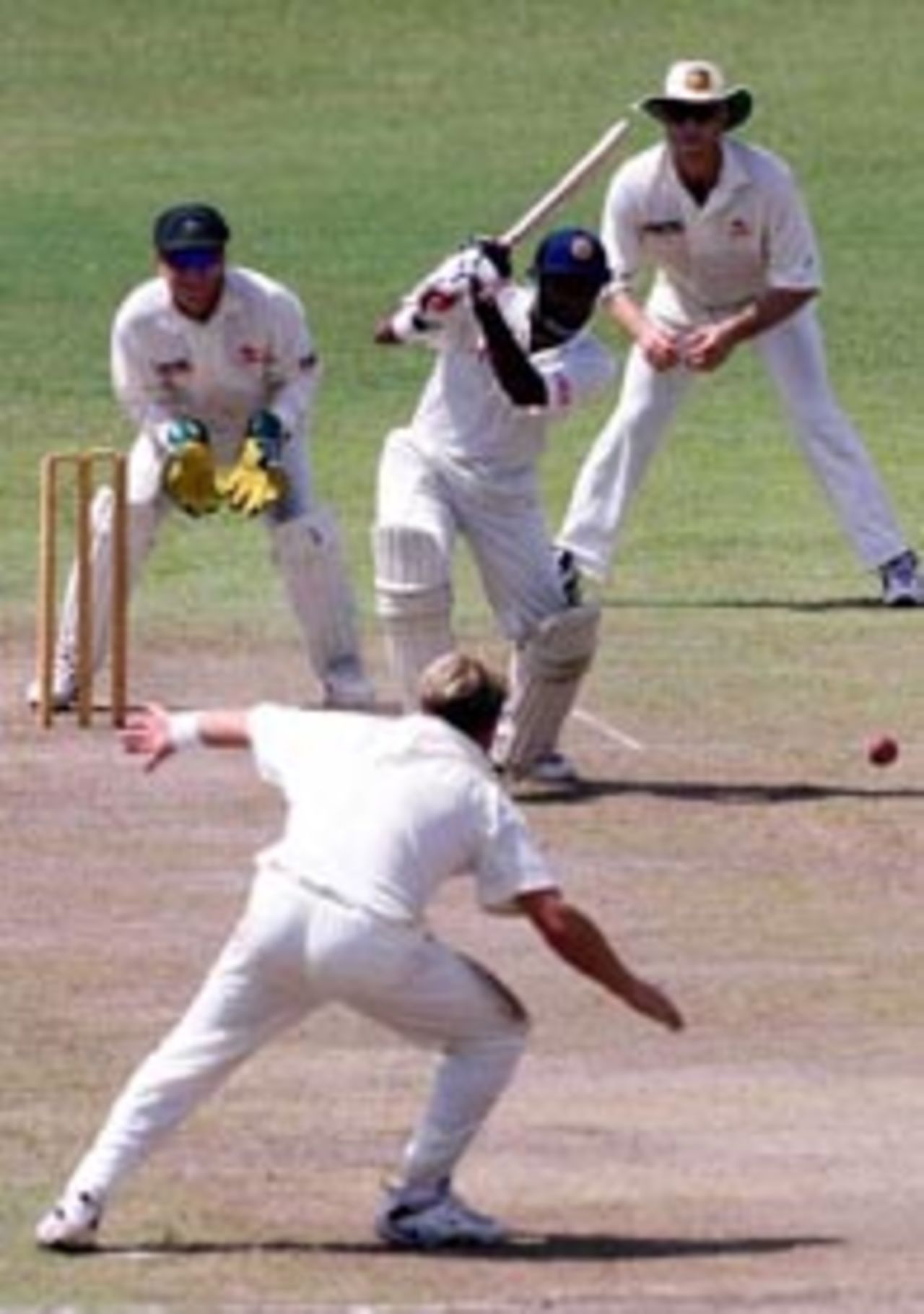 5 Sep 1999: Hashan Tillekearatne of the Board XI drives for four past Shane Warne of Australia with Ian Healy and Mathew Hayden looking on, during day three of the tour match between the Sri Lanka Board XI and Australia at Saravanamuttu Stadium, Colombo, Sri Lanka.
