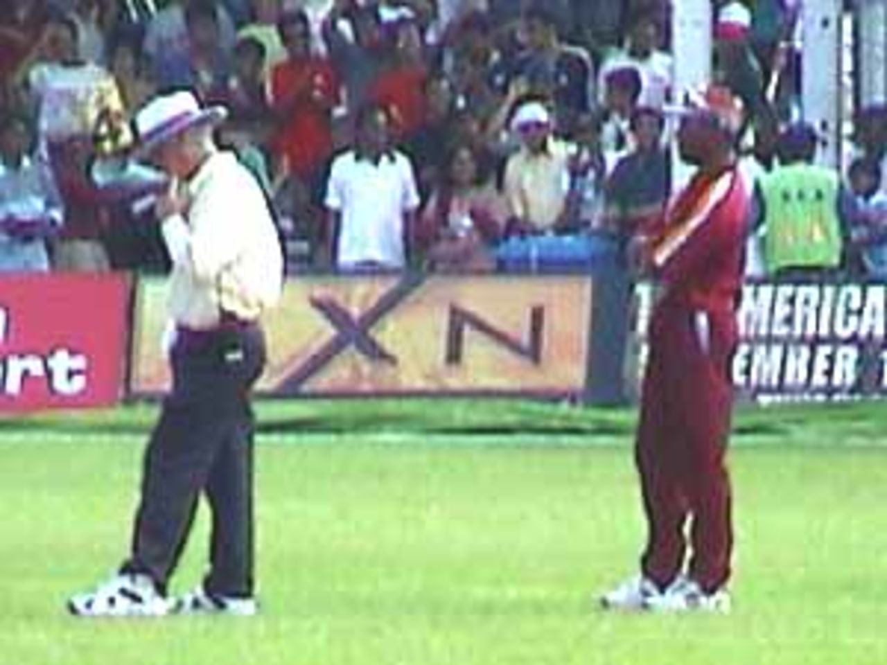 Umpire Rudi Koertzen and the square-leg fielder deep in thought, India v West Indies (3rd ODI), Coca-Cola Singapore Challenge, 1999-2000, Kallang Ground, Singapore, 5 Sep 1999.