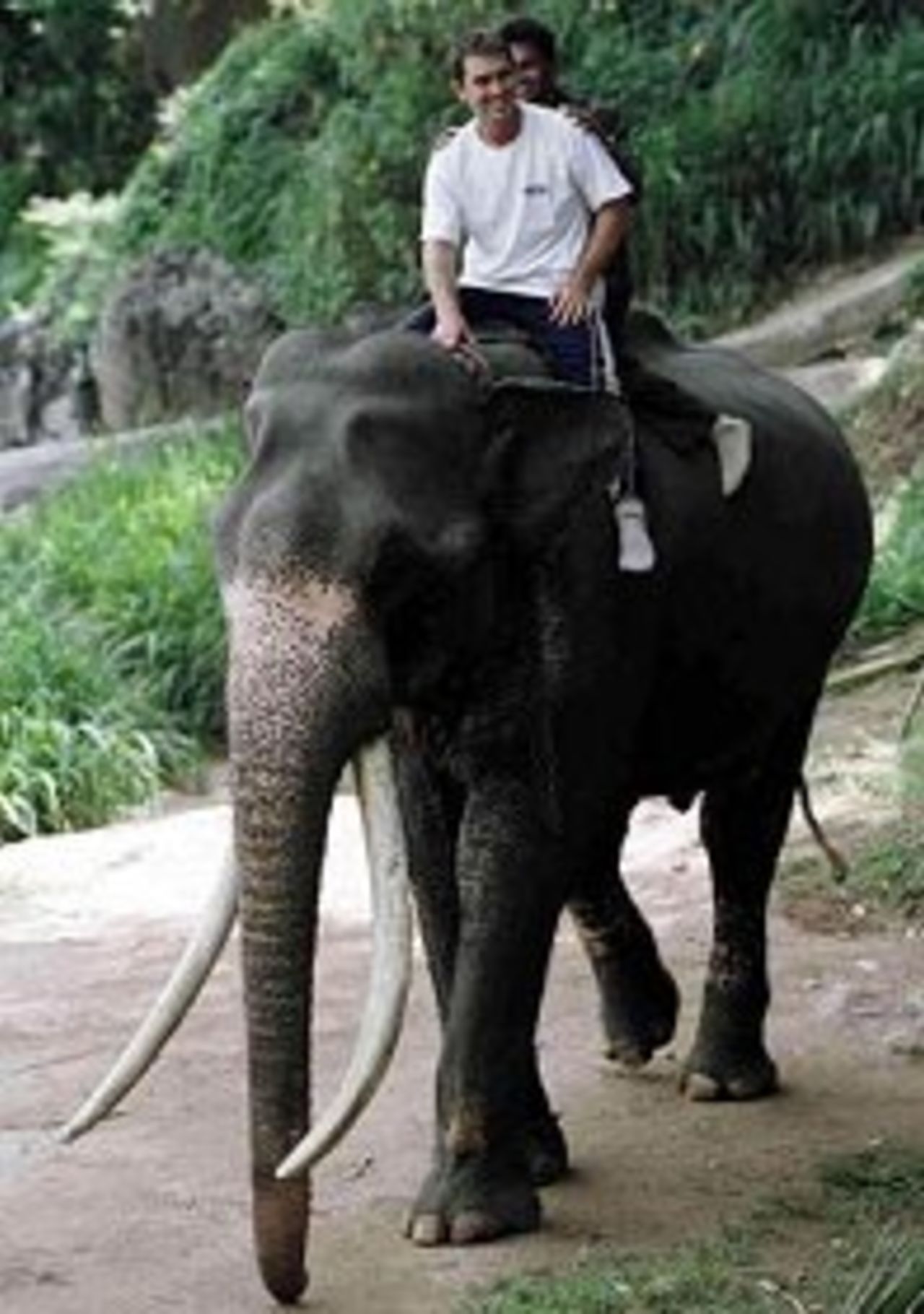 Justin Langer enjoys a ride on an elephant at Kandy's Elephant Sanctuary. 8 Sep 1999