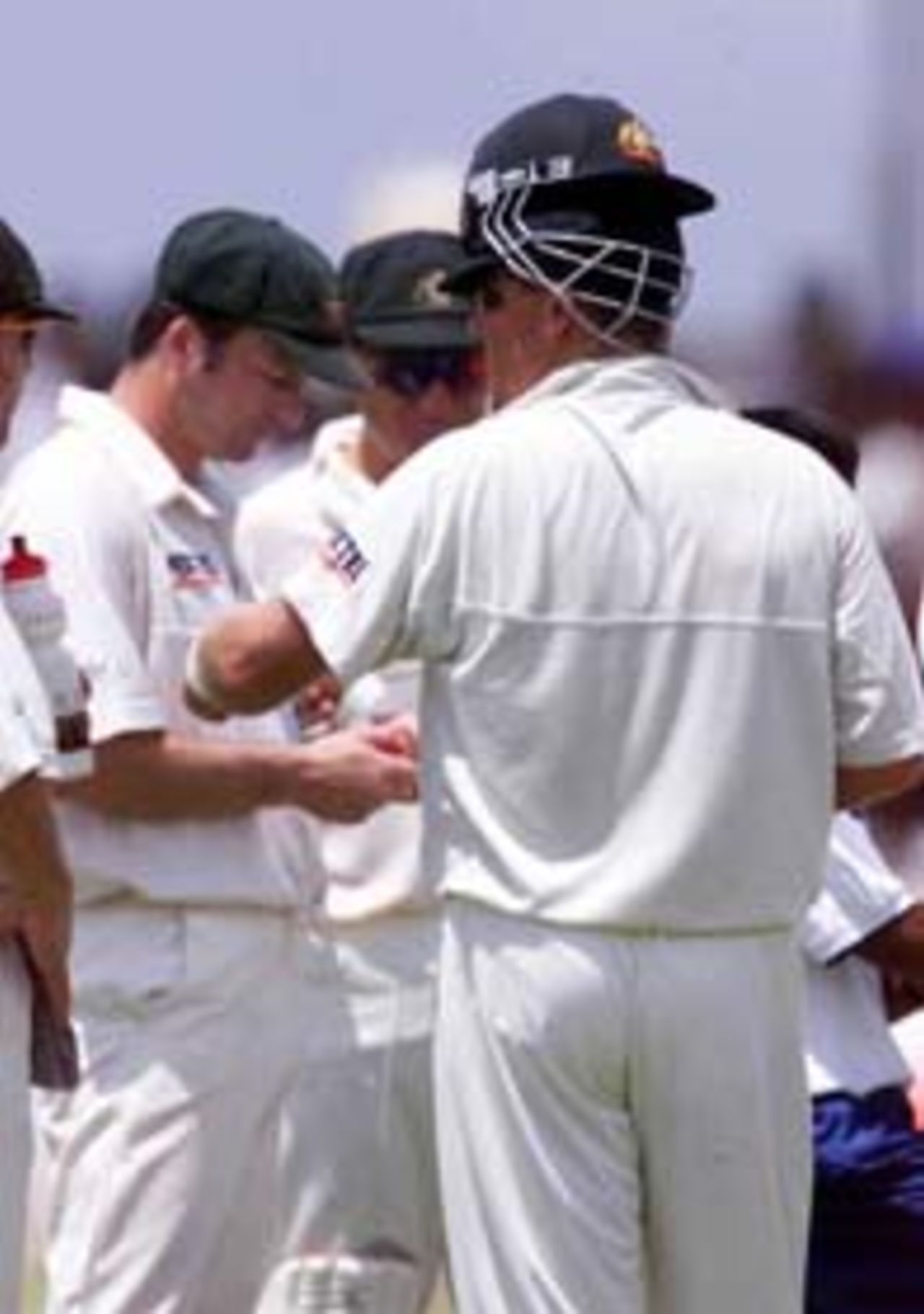 22 Sep 1999: Shane Warne of Australia wearing a helmet back to front, with Steve Waugh in the background, during day one of the second test between Sri Lanka and Australia at Galle International Stadium, Galle, Sri Lanka.