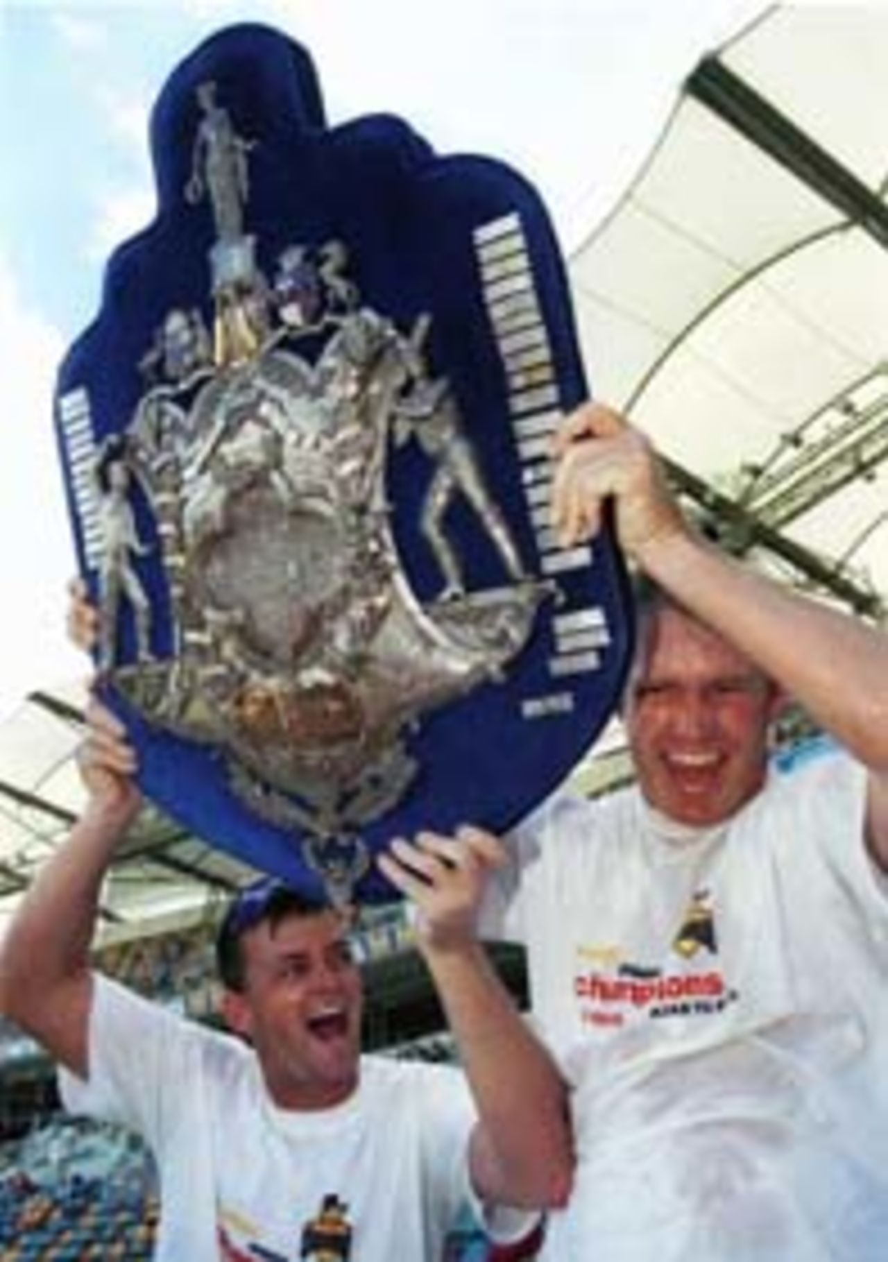 22 March 1999: Adam Gilchrist vice captain and Tom Moody captain of the Western Australian Cricket team celebrate after winning the Sheffield Sheild final defeating Queensland by an innings at the GABBA, Brisbane Australia.
