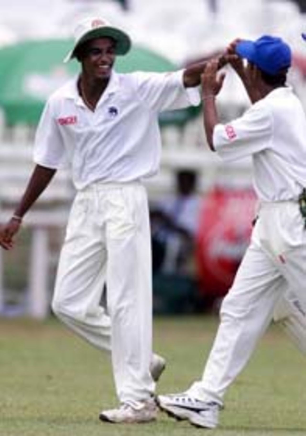17 Sep 1999: Suresh Perera congratulates Nimish Perera (R) of the Board XI who caught Ricky Ponting of Australia, during day one of the Tour match between the Sri Lanka Board XI and Australia at Colombo Cricket Club, Colombo, Sri Lanka.