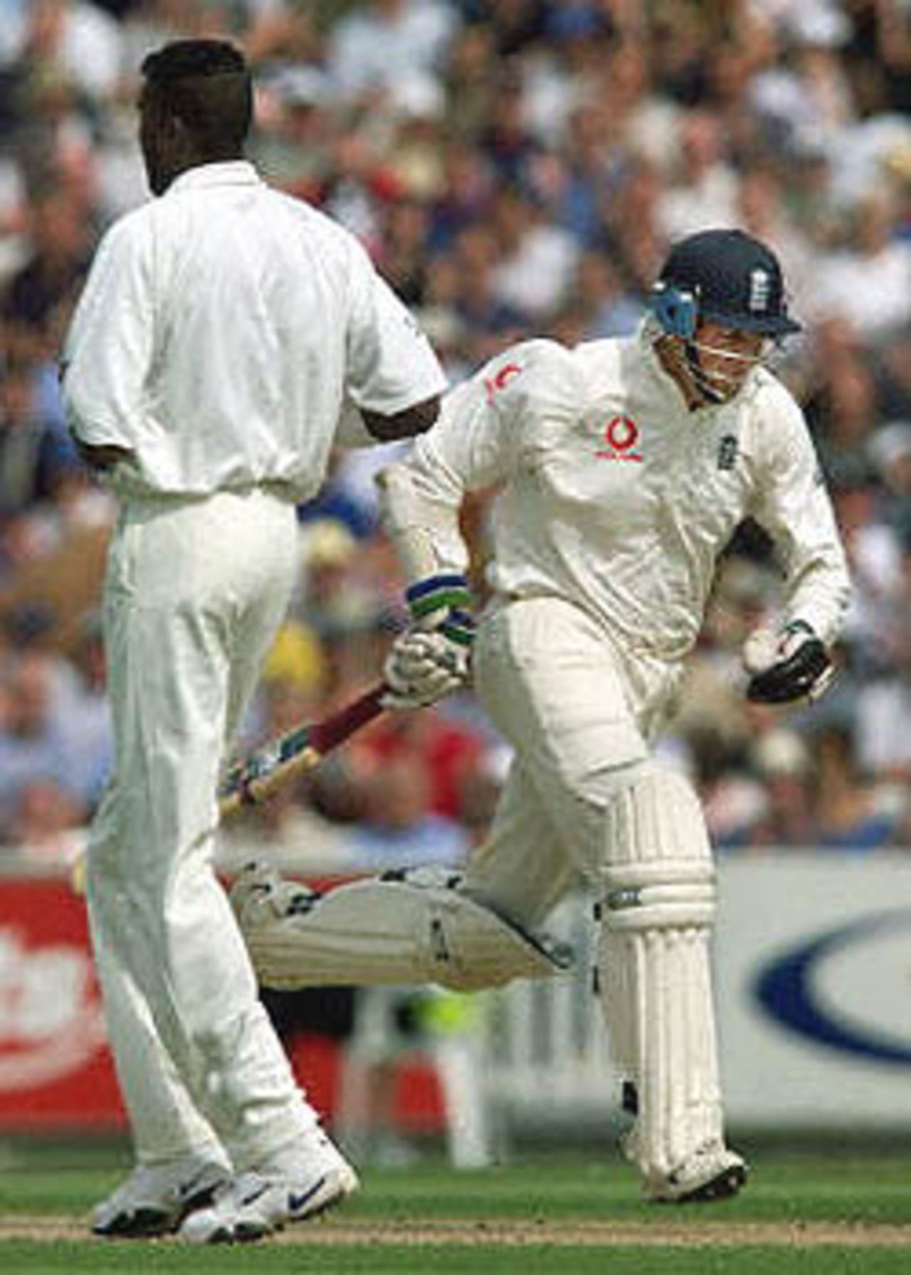 England's opening batsman Marcus Trescothick (R), runs past Curtly Ambrose of the West Indies during the first session of the Fifth Test against England at the Oval in London. Trescothick made 30 runs before lunch and England didn't lose a wicket. The Wisden Trophy, 2000, 5th Test, England v West Indies, Kennington Oval, London, 31Aug-04Sep 2000 (Day 1).