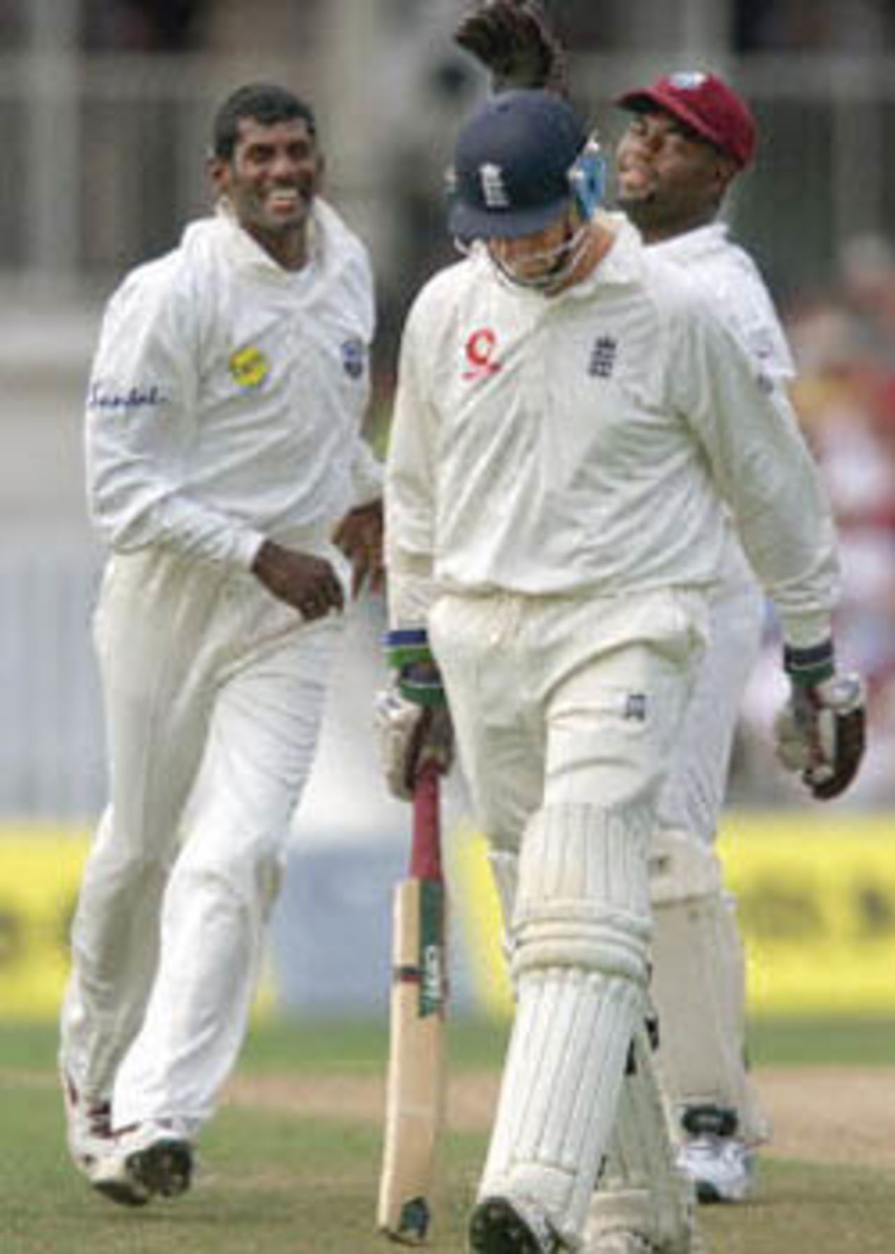 England's opening batsman Marcus Trescothick (R) walks off after being caught while West Indies bowler Mahendra Nagamootoo (L) celebrates shortly before the afternoon interval during Fifth Test against the West Indies at the Oval in London, Trescothick scored 78. The Wisden Trophy, 2000, 5th Test, England v West Indies, Kennington Oval, London, 31Aug-04Sep 2000 (Day 1)