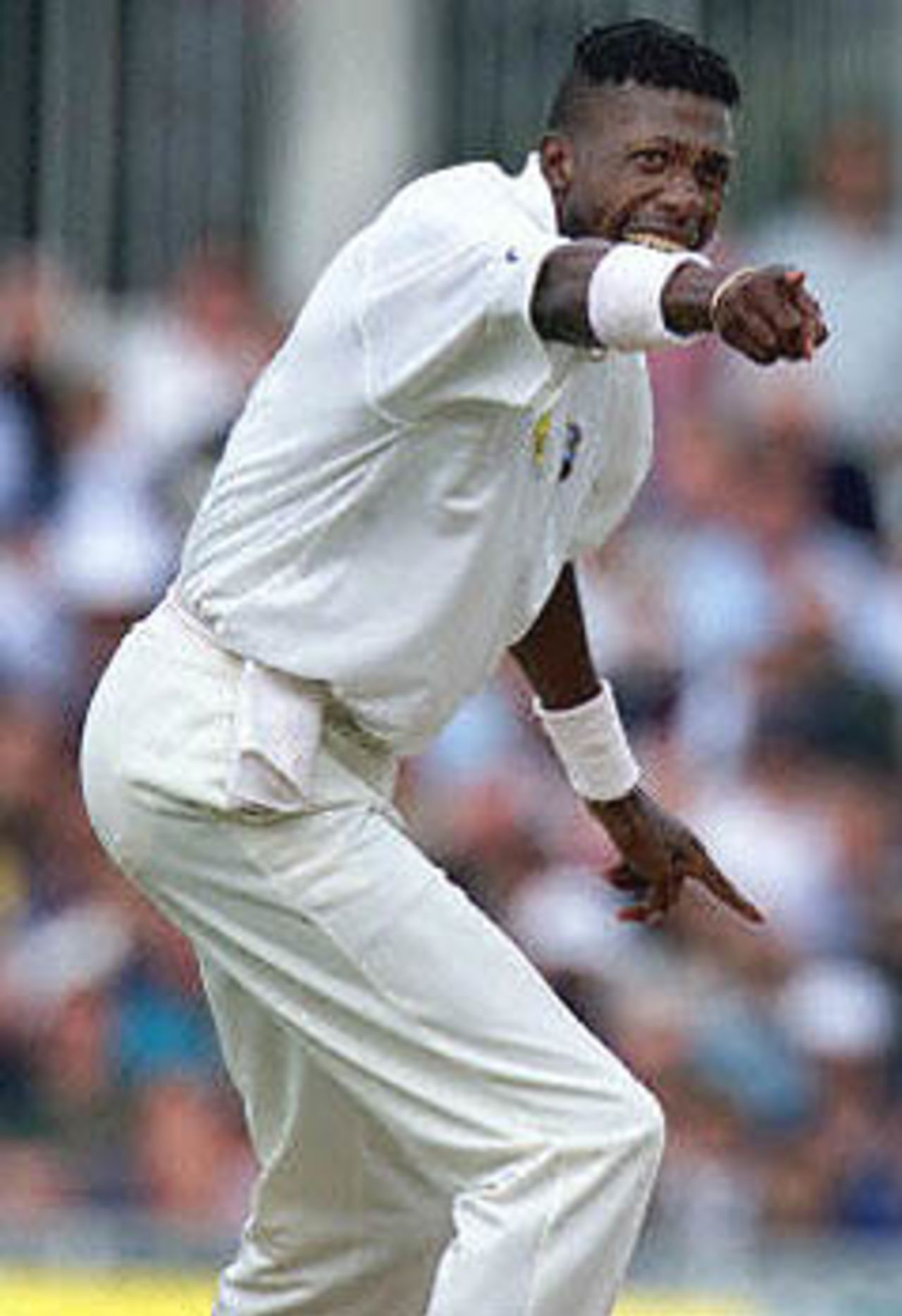 Curtly Ambrose, of the West Indies, celebrates after taking the wicket of Graeme Hick during the second day of the Fifth Test against England at the Oval in London. Ambrose took two wickets for 37 runs in his first 31 overs. Rain has since stopped play with England 256 for eight. The Wisden Trophy, 2000, 5th Test, England v West Indies, Kennington Oval, London, 31Aug-04Sep 2000 (Day 2)