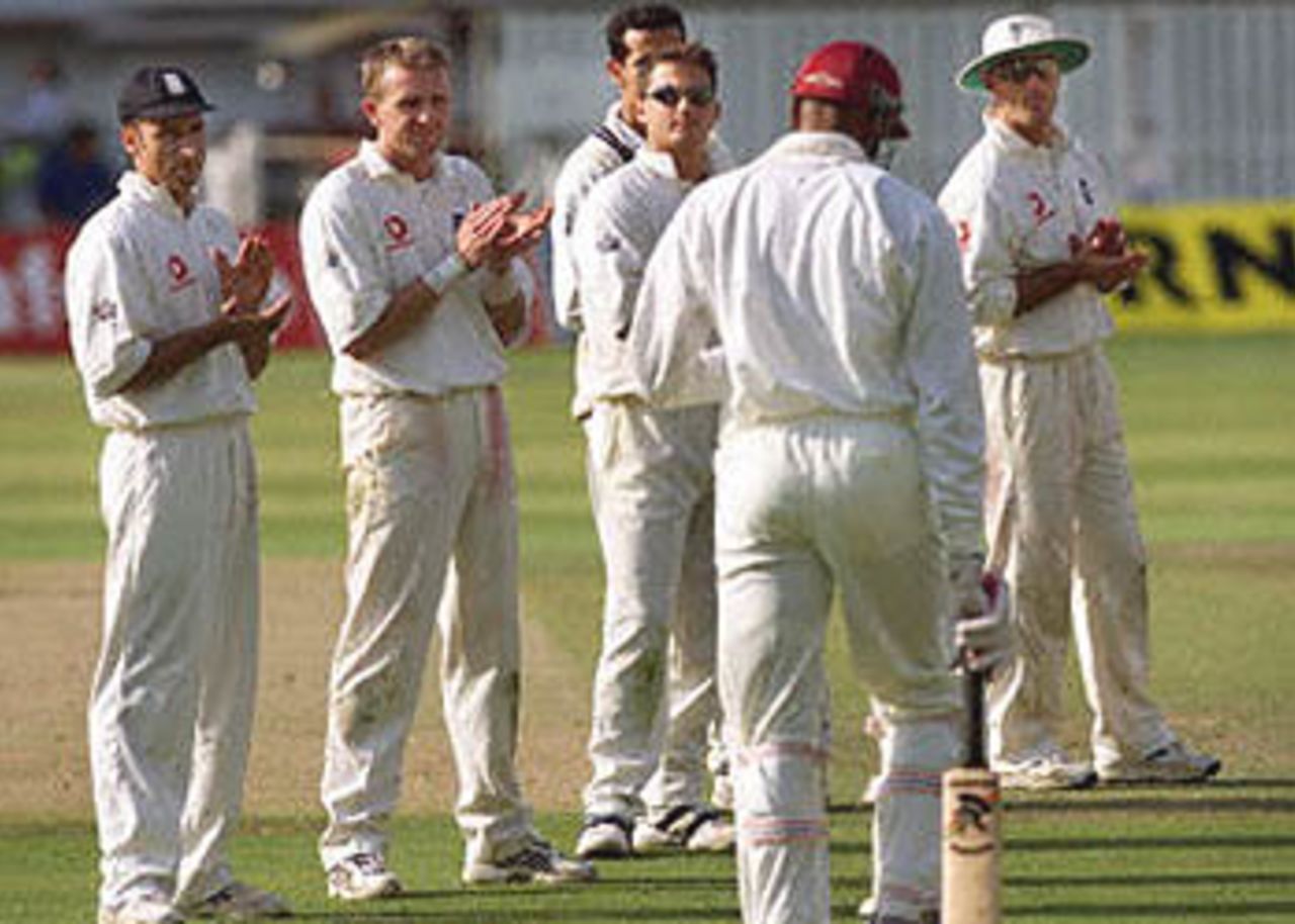 England's players Nasser Hussain (L), Dominic Cork (2nd L), Darren Gough (3rd L) and Graeme Thorpe (R) applaud West Indies bowler Courtney Walsh as he walks on to the field at the Oval in London. Walsh has said he may retire from international cricket. England won the five-match series 3-1 breaking the longest running losing streak in test cricket. The Wisden Trophy, 2000, 5th Test, England v West Indies, Kennington Oval, London, 31Aug-04Sep 2000 (Day 5).