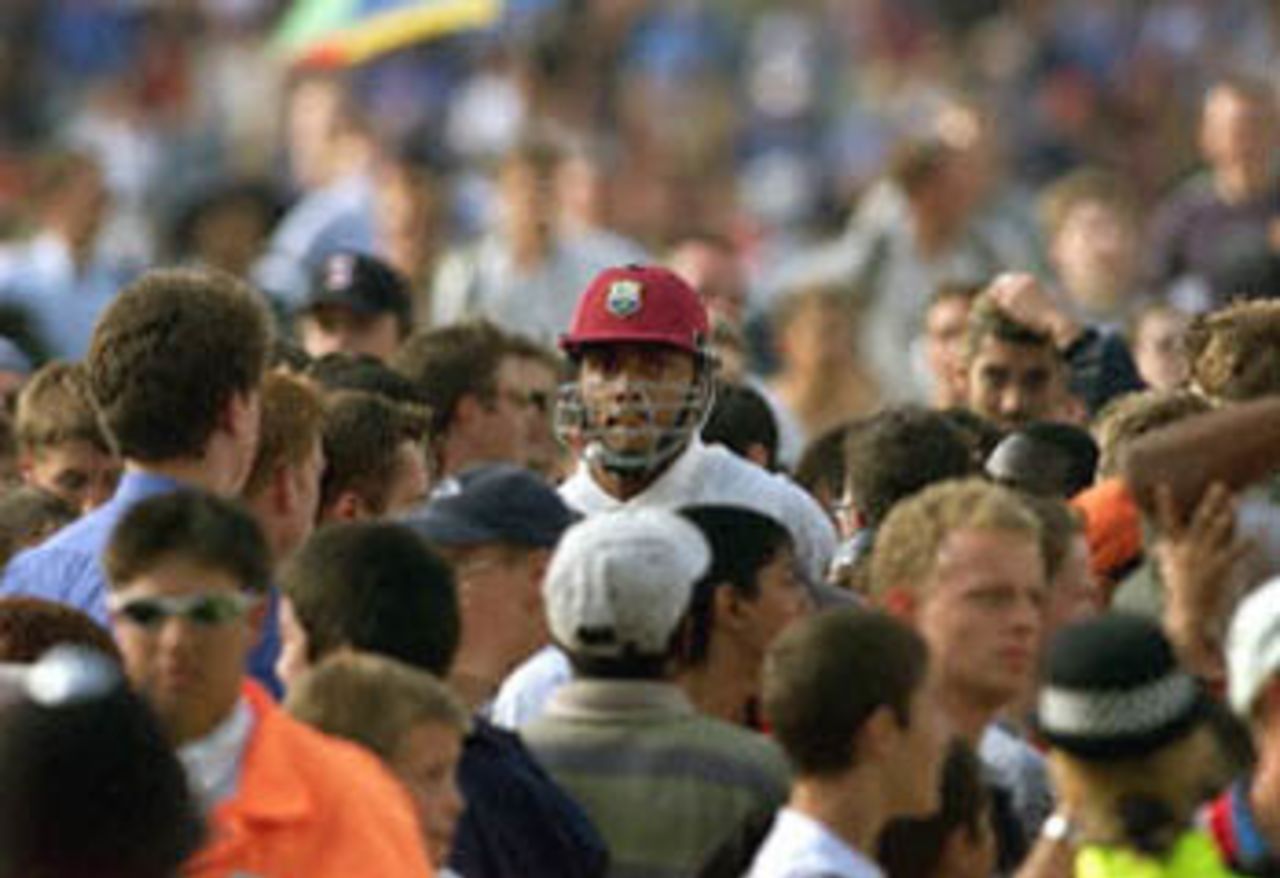 Courtney Walsh (C) walks through the crowds after the West Indies were bowled out against England in the Fifth Test at the Oval in London. Walsh has said he may retire from international cricket. England won the test and the five-match series 3-1 breaking the longest running losing streak in test cricket. The Wisden Trophy, 2000, 5th Test, England v West Indies, Kennington Oval, London, 31Aug-04Sep 2000 (Day 5).