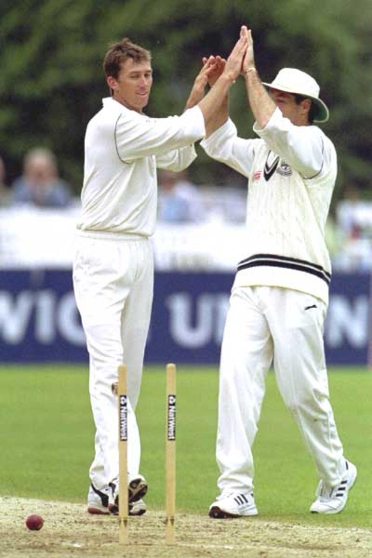 4 July 2000: Glenn McGrath of Worcestershire is congratulated by his team-mate after he bowled out Michael Cawdron of Gloucestershire in the third round replay of the Natwest Trophy match at Worcester. McGrath took four wickets for 23